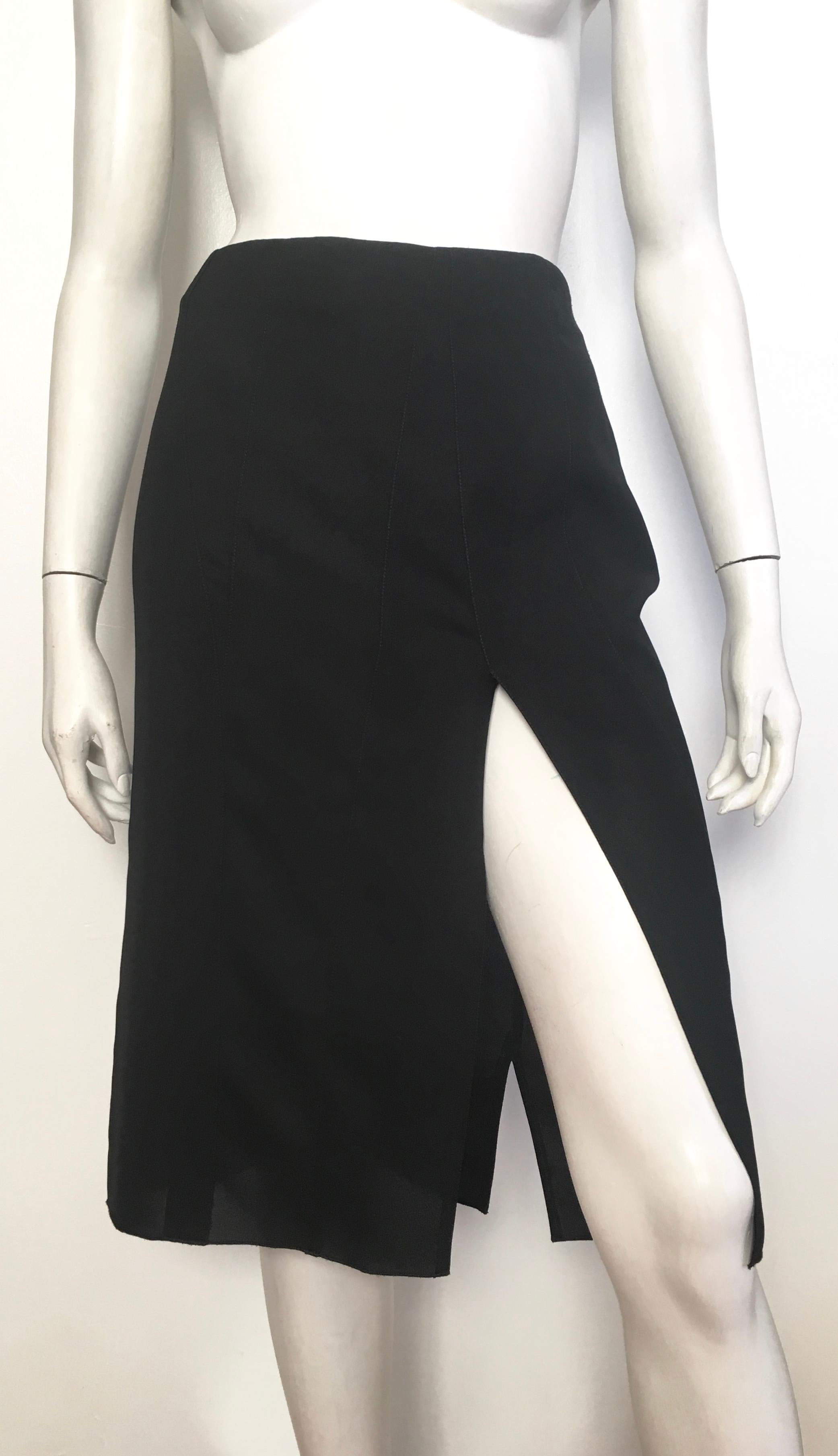 Donna Karan New York 1990s black sheer skirt with sexy angular slit in front is a size 8.  The waist on this skirt is 33. 3/4