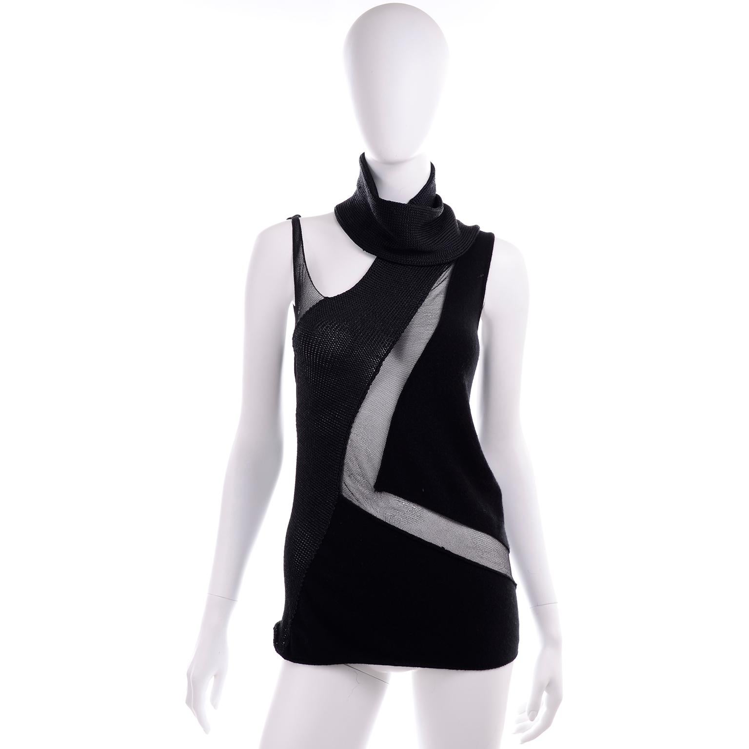 This gorgeous vintage 1990s Donna Karan black knit sleeveless top has a scarf attached at the neckline and peek a boo sheer mesh panels. The top has snap closures to secure bra and slips overhead. This would be a great piece to wear with trousers or