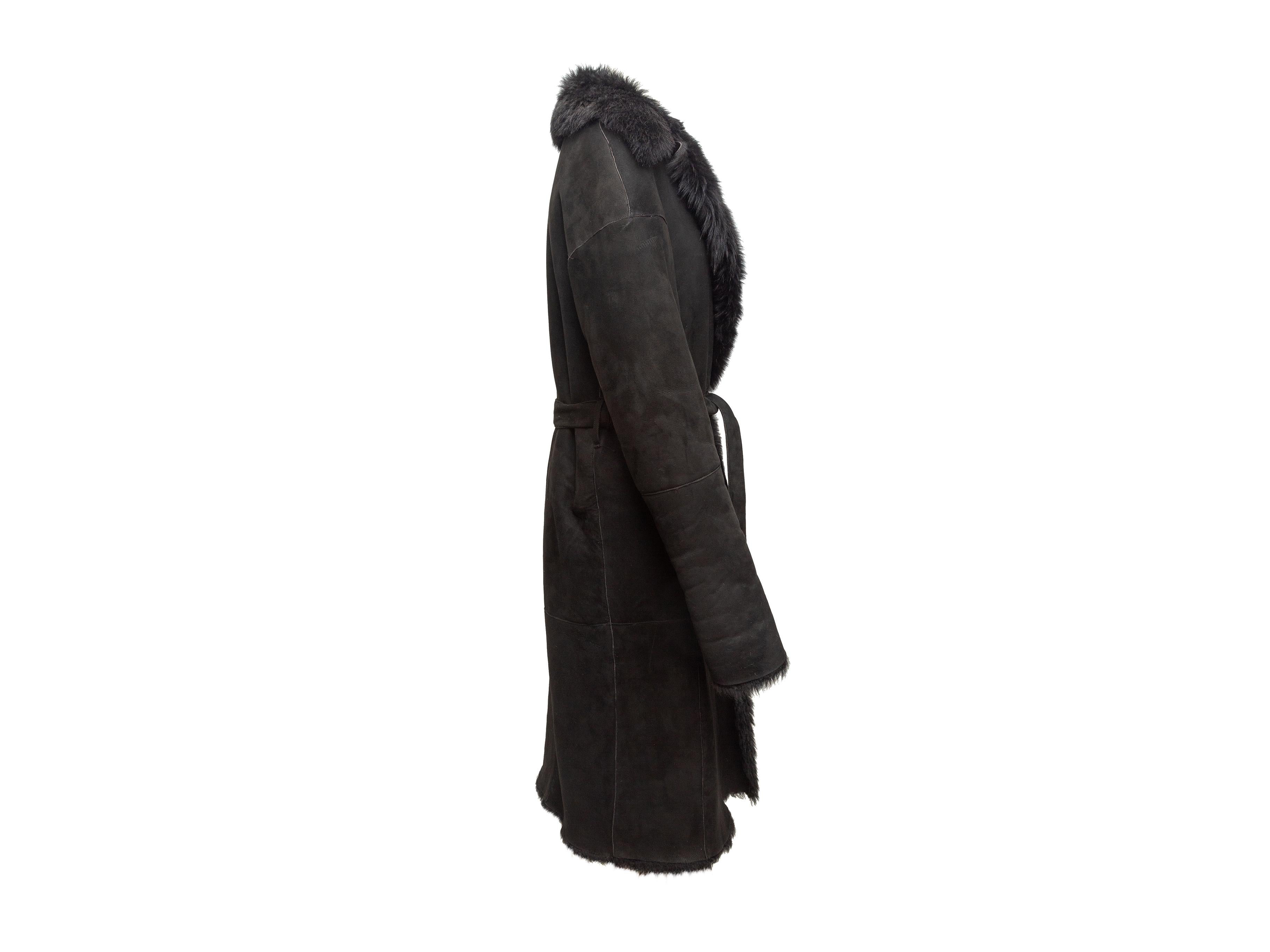 Product details: Black long shearling coat by Donna Karan. Notched collar. Sash tie at waist. 30