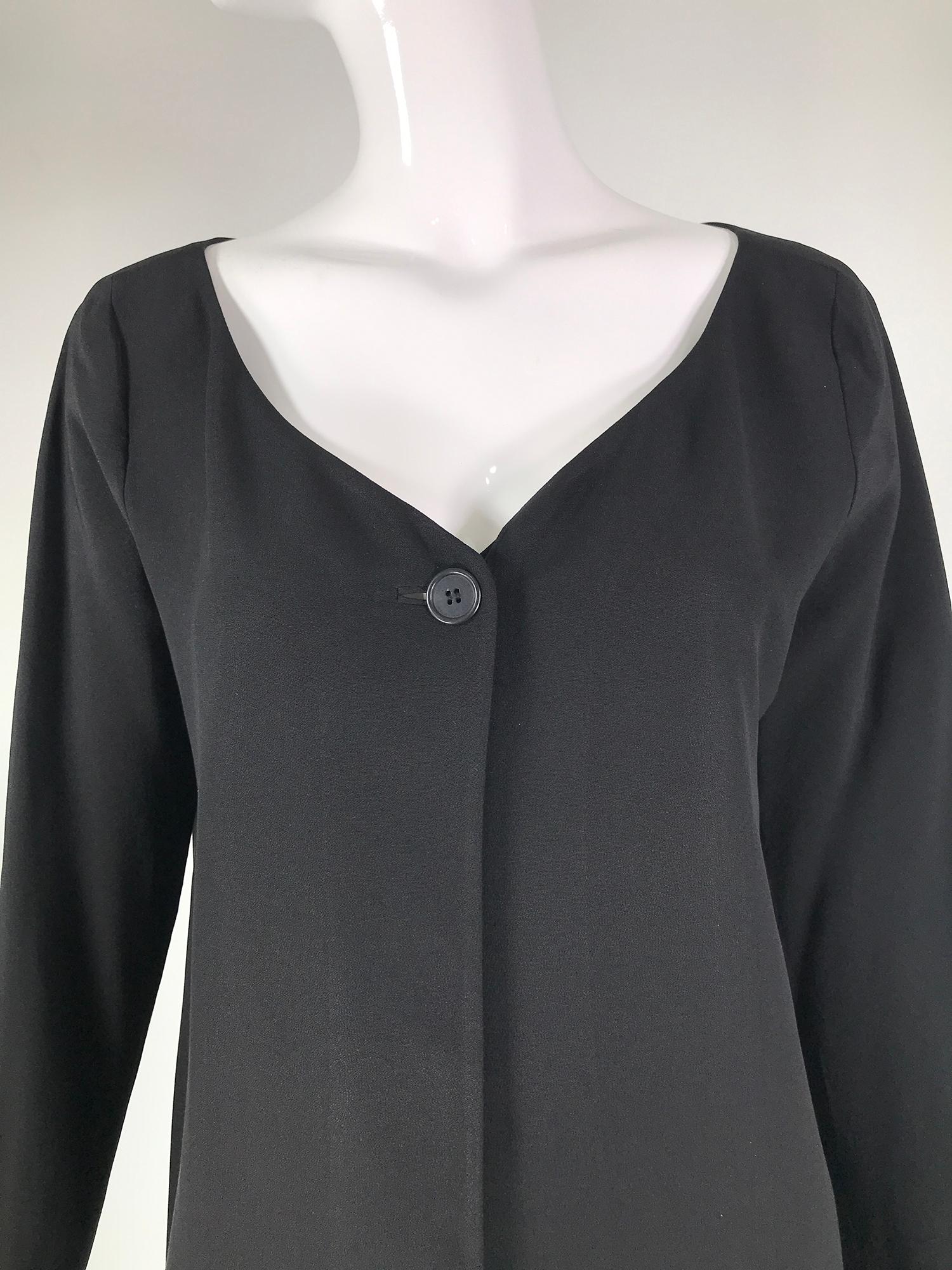 Donna Karan black silk crepe, open front jacket with pockets 1980s. V neckline,  long sleeve, princess seam jacket closes with a single button at the neck top, the jacket is below hip length, with hip front besom pockets. The jacket is lined in