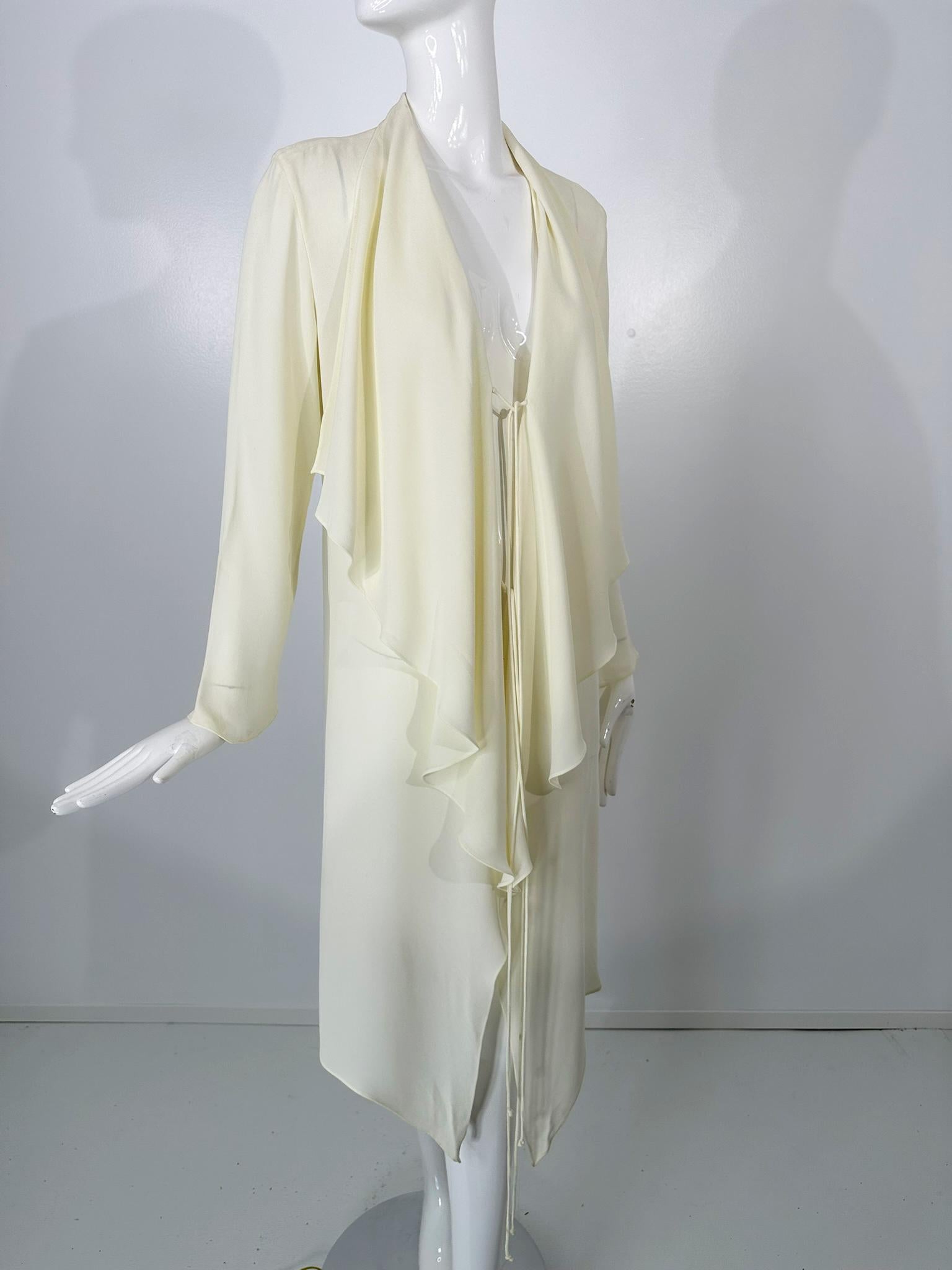 Vintage 1980s Donna Karan Black Label butter yellow, tie front, lightweight crepe coat. Great layering piece when you want a little cover up. Soft yellow, long sleeves with a slight bell cuff, deep draped lapels and 2 self cord ties at the front.