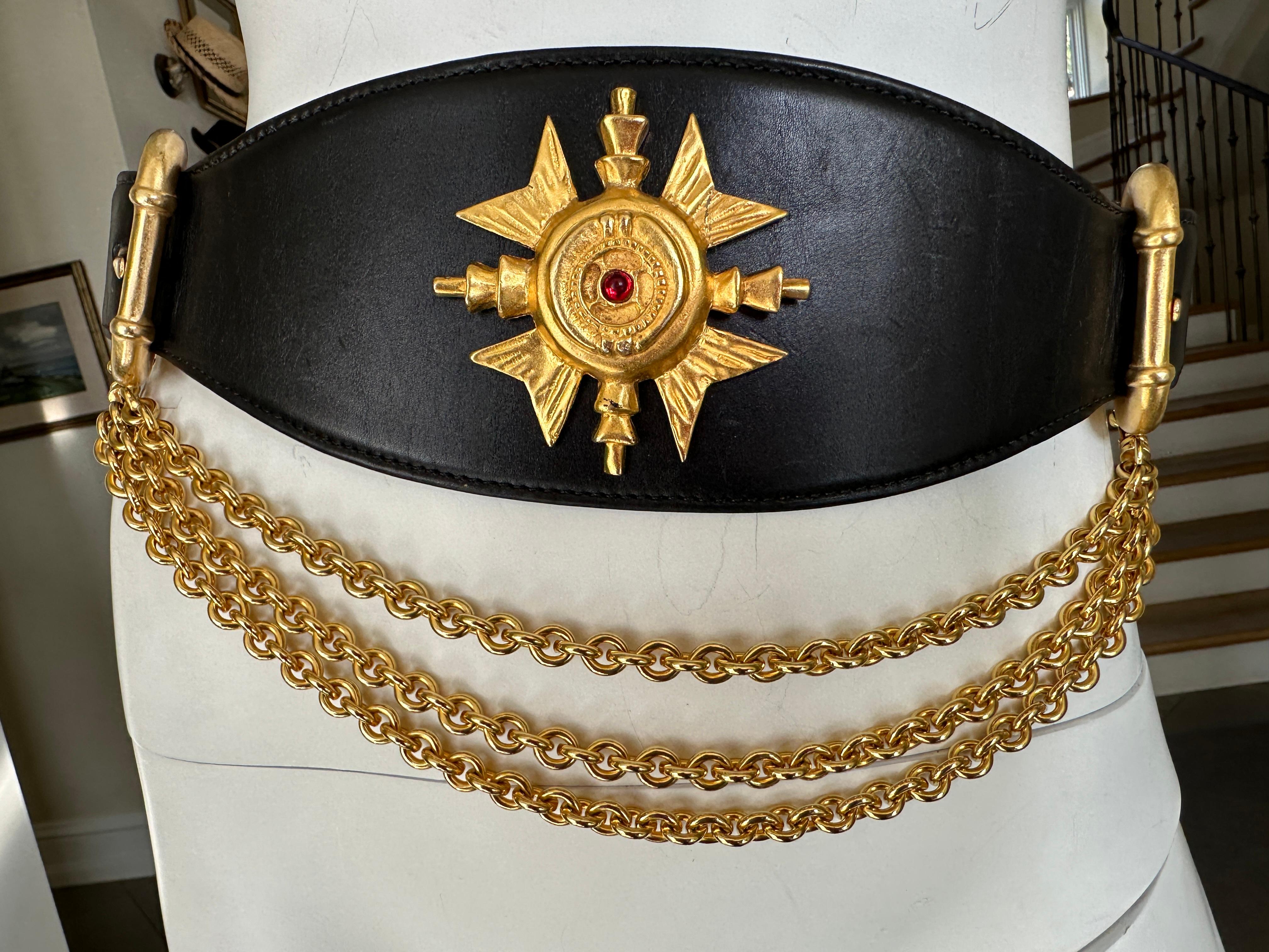 Donna Karan Collectable Vintage Wide Leather Belt w Gold Cross and Chain Details.
The chain section is detachable.
Excellent pre owned condition
Fits 30-36