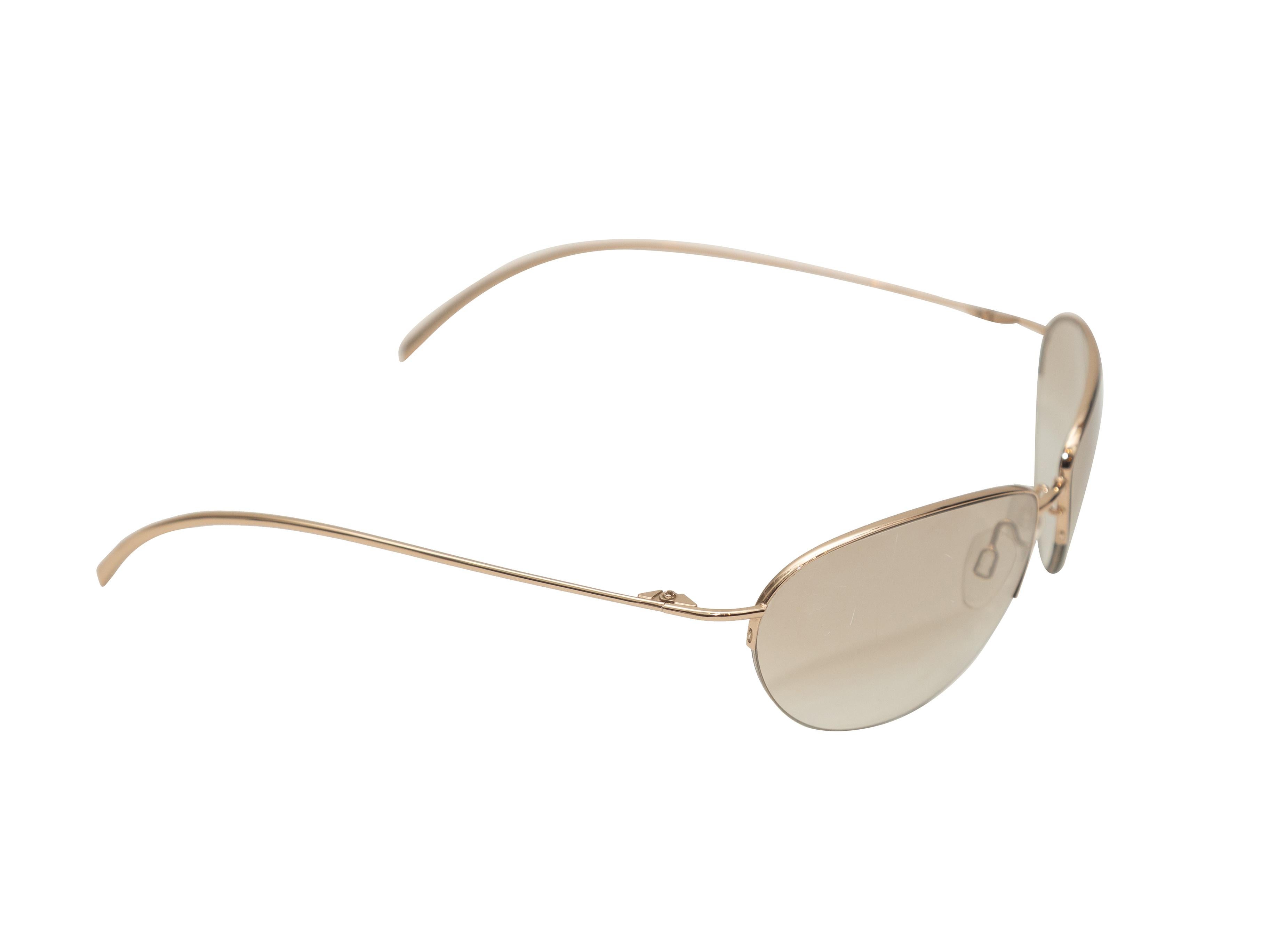 Product Details: Vintage gold metal sunglasses by Donna Karan. Brown tinted lenses. 1.5