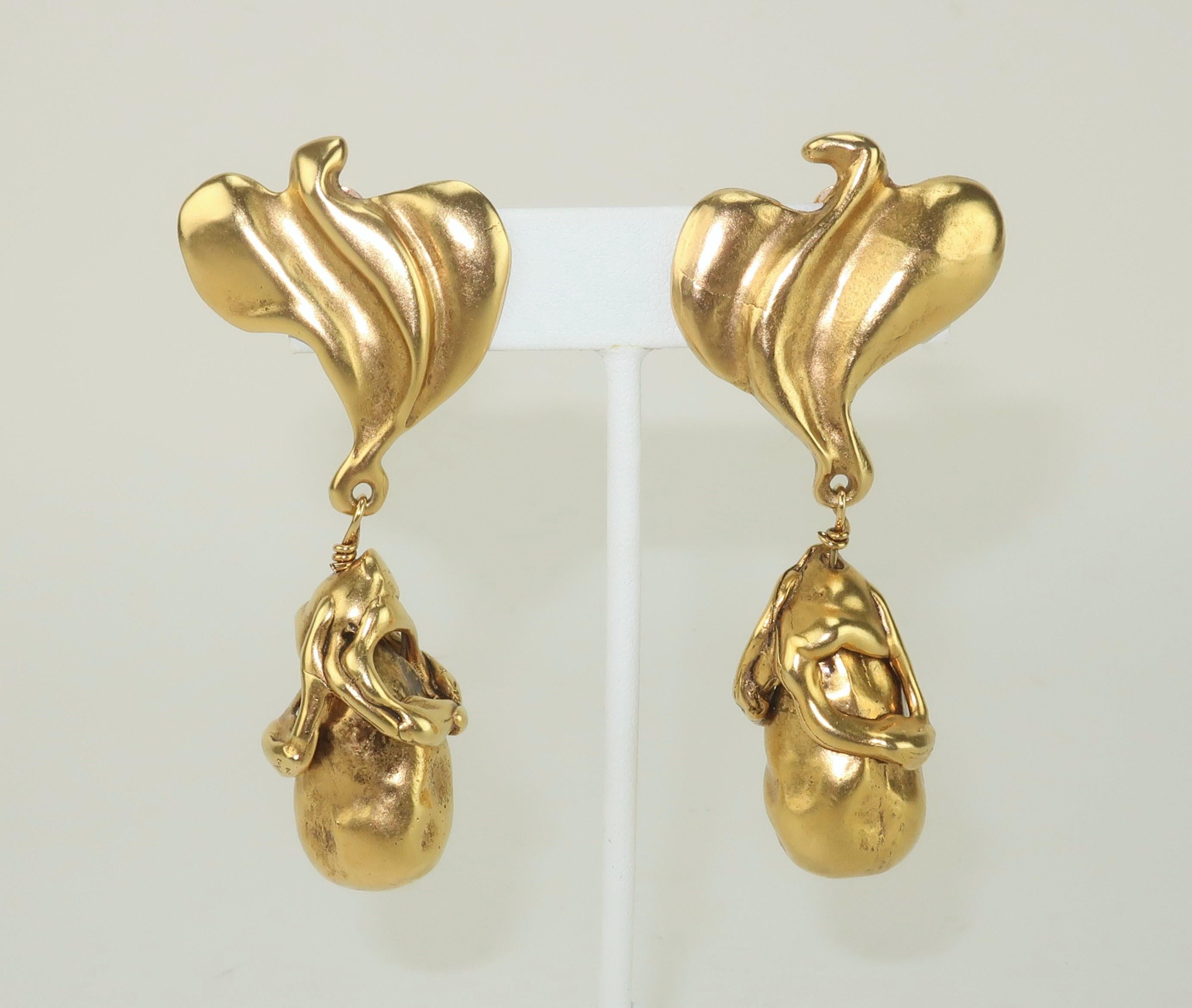 Late 20th Century Donna Karan gold tone clip on earrings depicting abstract birds and brutalist style drop dangles.  The earrings are beautifully made with quality details and a modernist look.  Hallmarked 'D. K.' at the back.  Please see the Modern