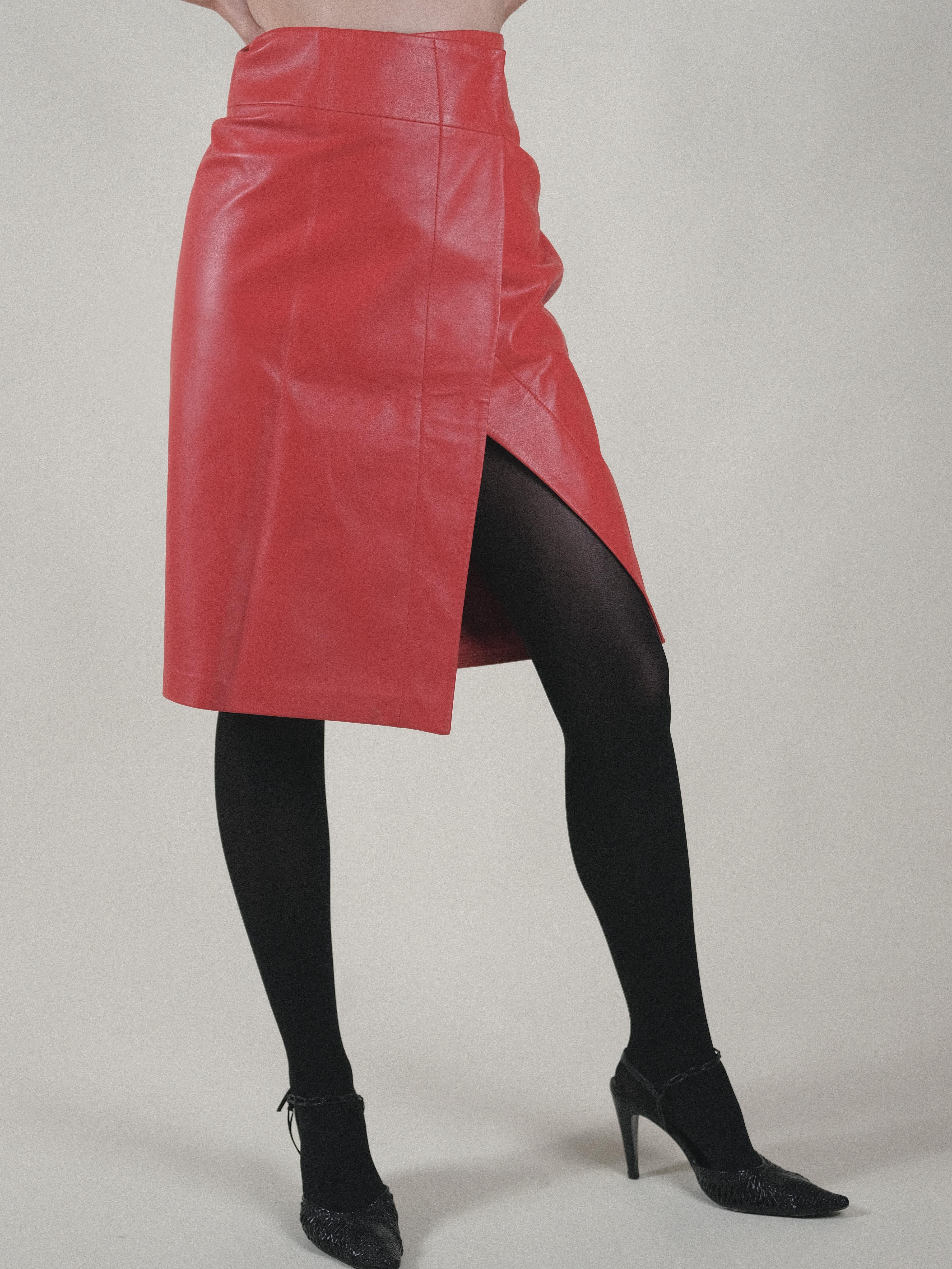 1990's Donna Karan Leather Wrap Skirt 
Perfect tomato red
Amazing fit with slit at left side with perfect stitching in the leather
100% Lambskin
Fully lined
US 4
IT40
FR38
Flat measurements
Waist 15 inches
Hips 17 inches 
Lenth 25 inches
Good