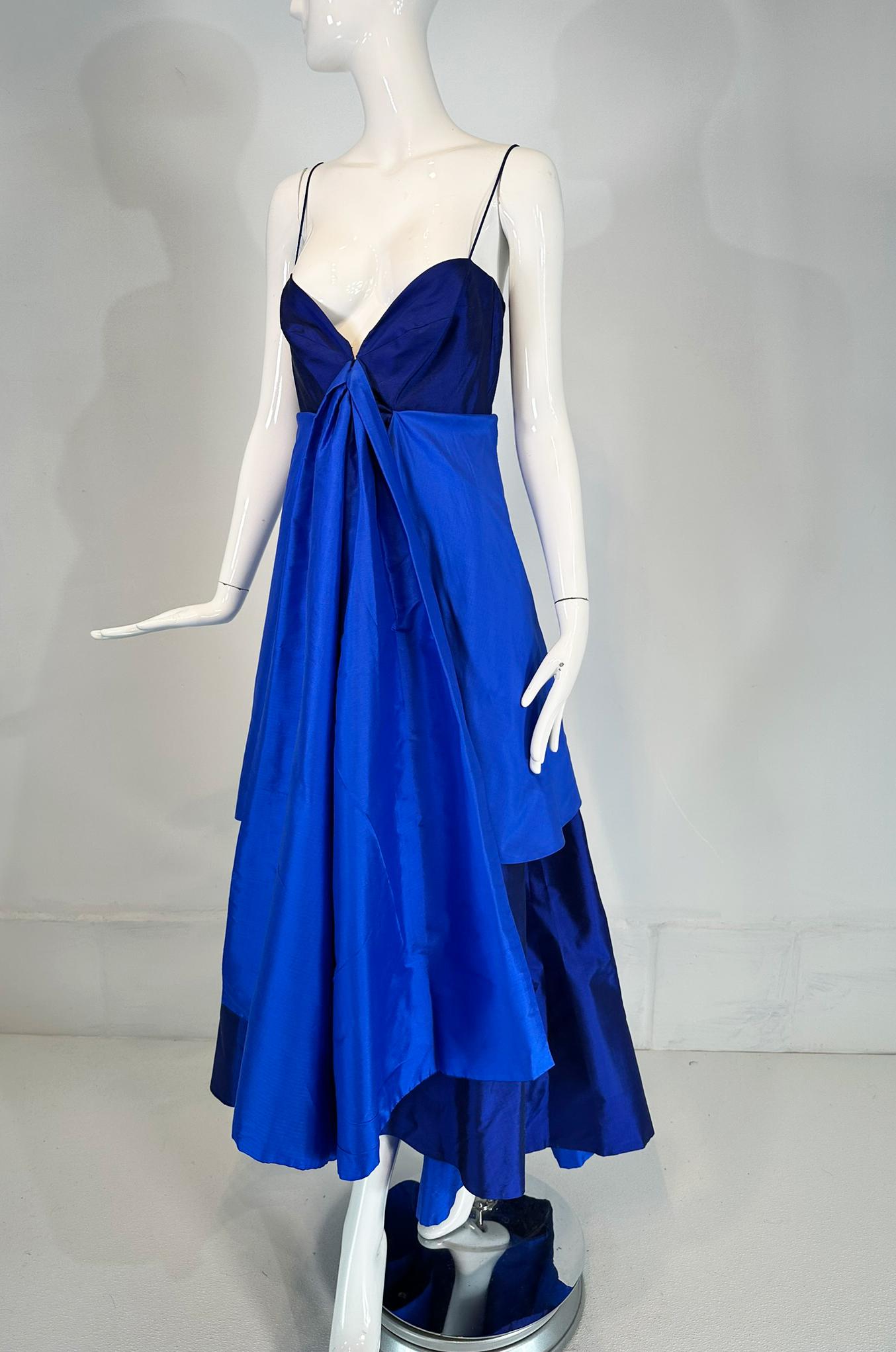Donna Karan navy & lapis blue silk spaghetti strap, slip gown with a long peplum over a high low hem skirt. This unique dress has skinny spaghetti straps and a bra top with boning that closes at the front with hidden hook eyes. The under skirt is