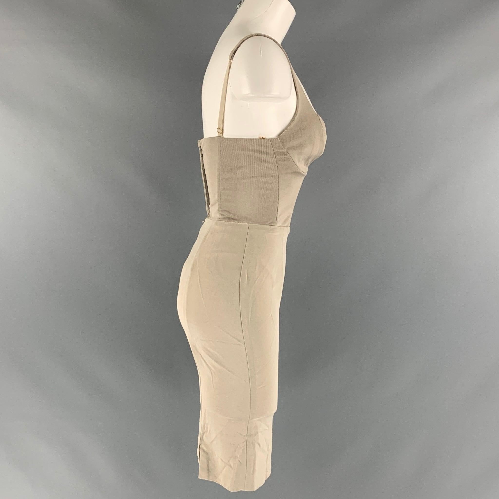 DONNA KARAN VINTAGE bustier dress comes in grey viscose knit material featuring a spaghetti strap bustier bodice top, body con skirt, and a hood and eye with zip up closure. Made in USA.Very Good Pre-Owned Condition. Moderate Signs of Wear.