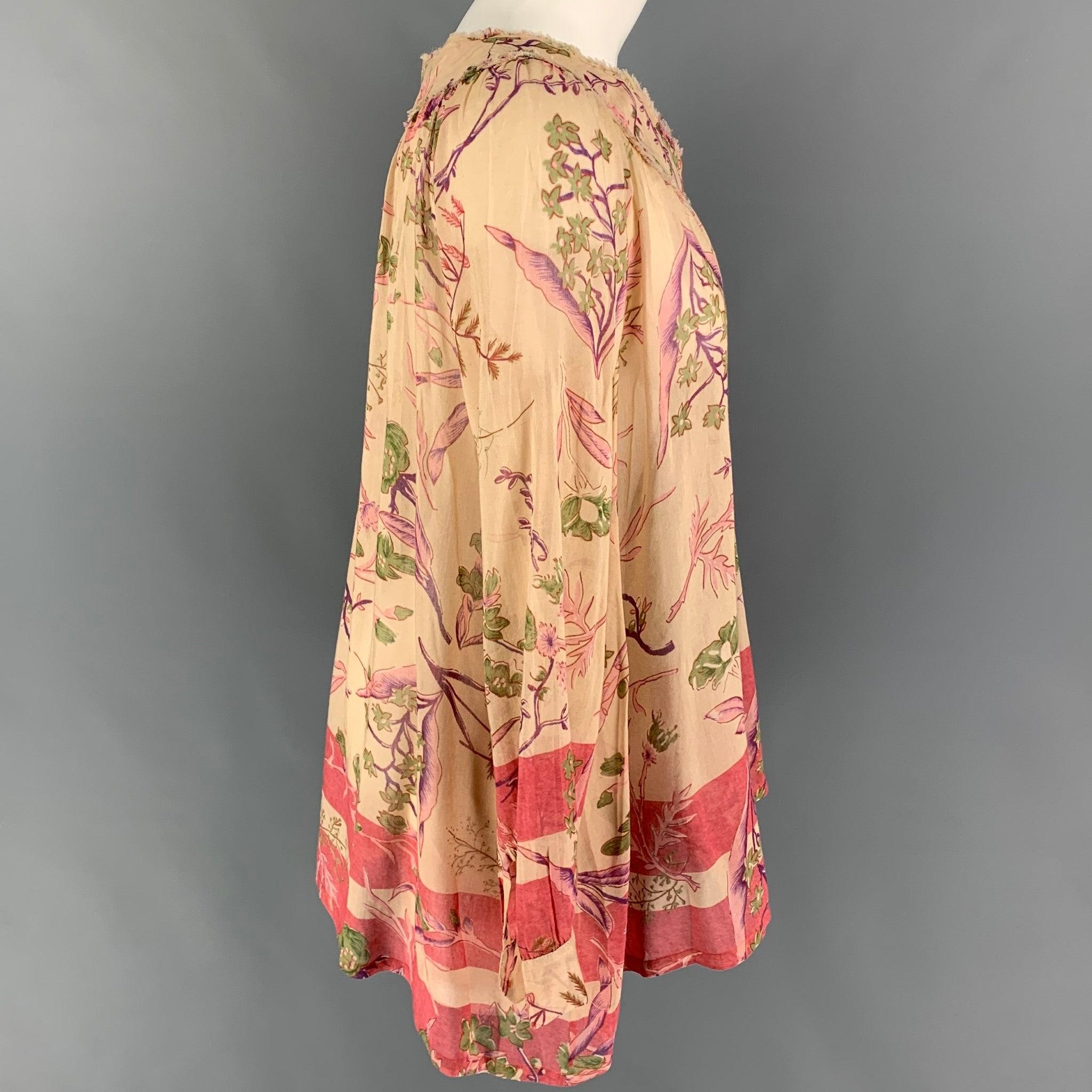 DONNA KARAN blouse comes in a beige & print floral silk featuring a tunic style, raw edge, and a buttoned closure.
Very Good
Pre-Owned Condition. 

Marked:   6 

Measurements: 
 
Shoulder: 16 inches  Bust: 42 inches  Sleeve: 24 inches  Length: 27