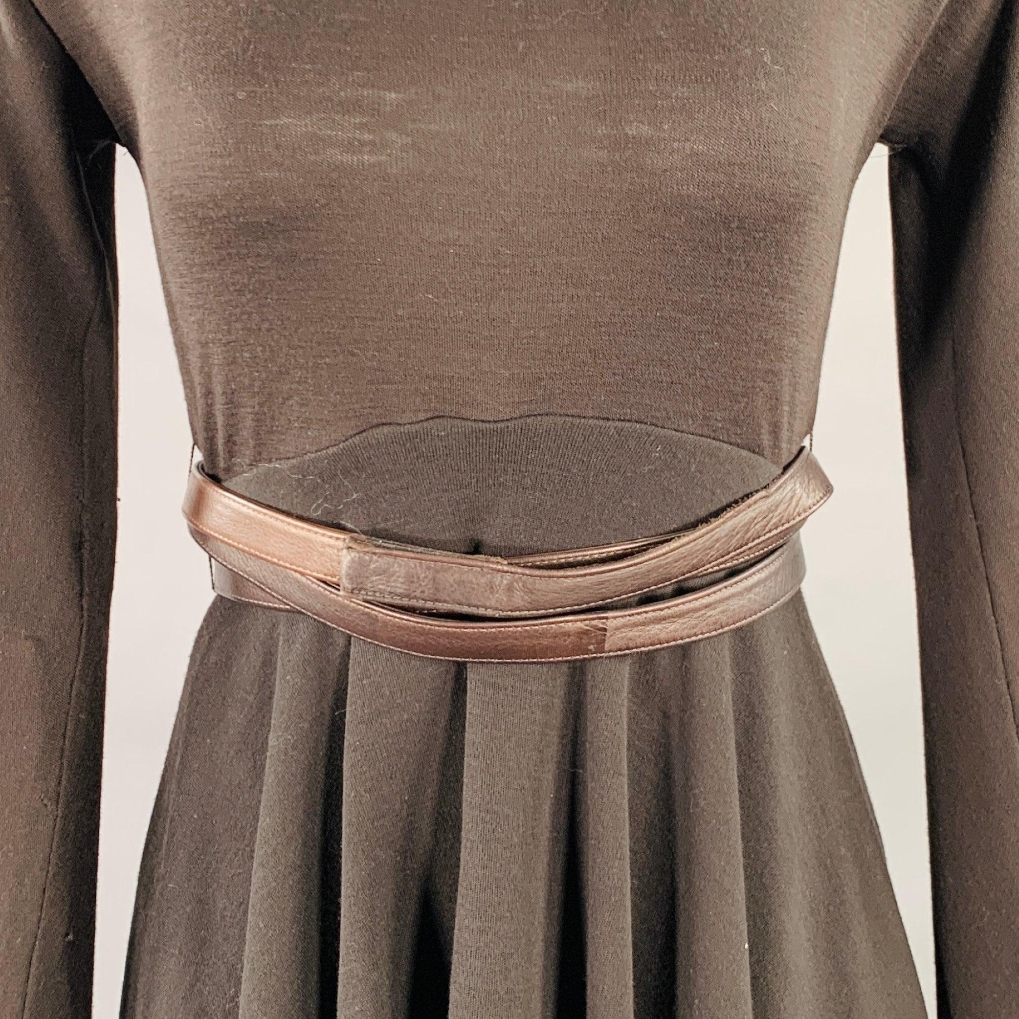 DONNA KARAN dress
in a brown wool jersey featuring an inner bodysuit, asymmetrical skirt hem, and back zipper closure with faux leather belt. Made in USA.Good Pre-Owned Condition. Moderate pilling on sleeve, as is. 

Marked:   6 

Measurements: 

