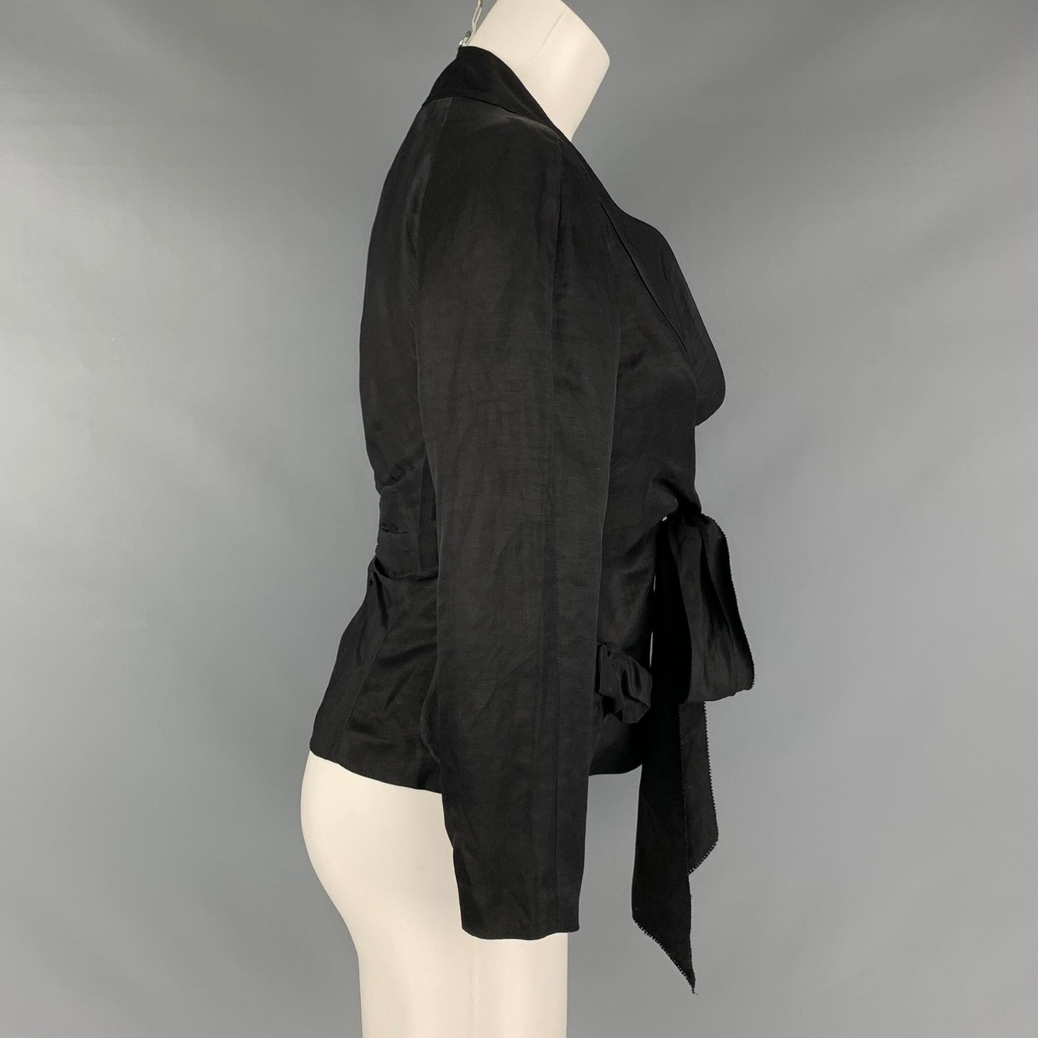 DONNA KARAN jacket comes in a black linen and viscose woven featuring a shawl collar, front tie detail, and a single button closure. Made in Italy.Very Good Pre-Owned Condition. 

Marked:    

Measurements: 
 
Shoulder: 12 inches Bust: 35 inches