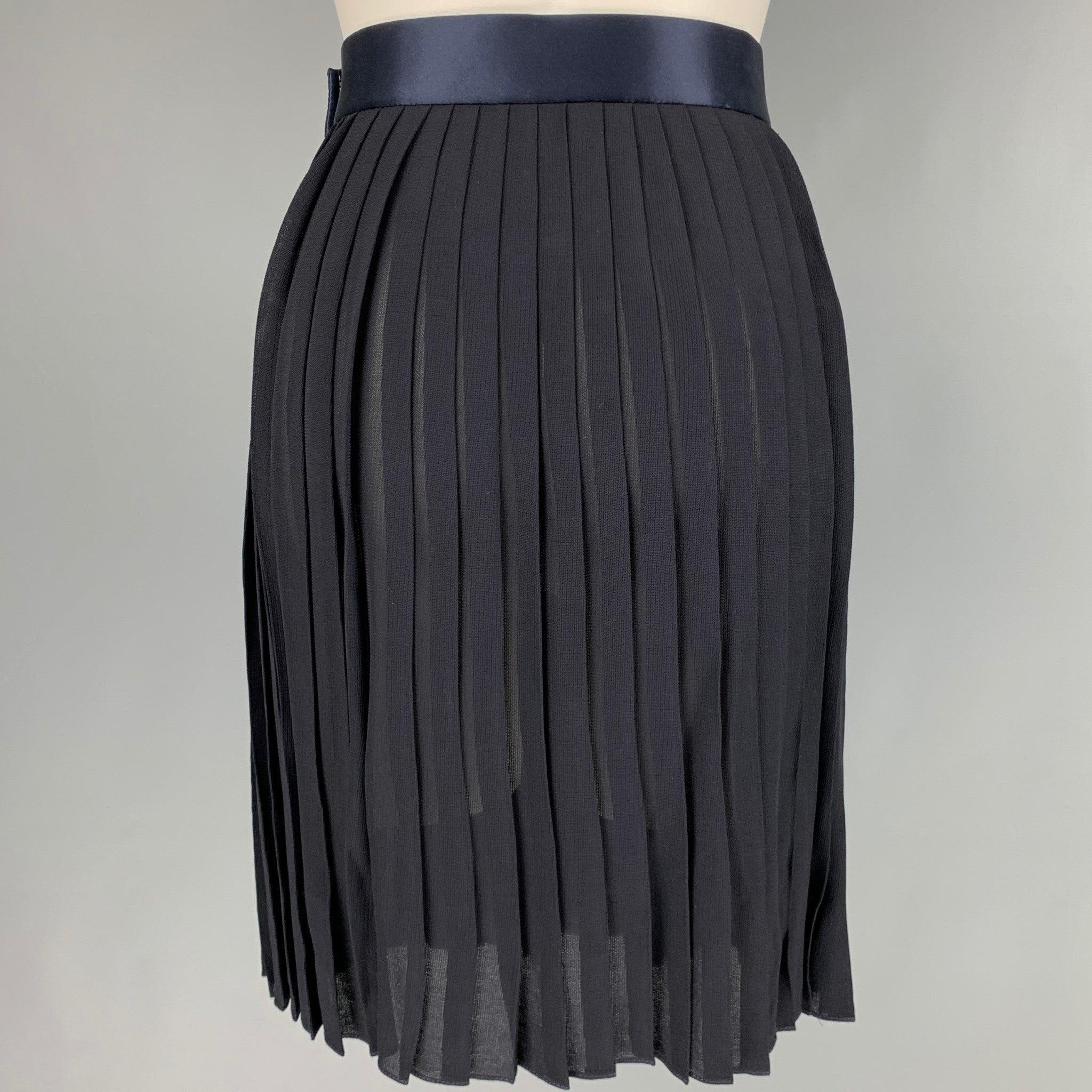 DONNA KARAN skirt
in a
navy rayon fabric featuring a pleated style, below knee length, satin waistband, and side snap closure. Made in USA.Excellent Pre-Owned Condition. 

Marked:   8 

Measurements: 
  Waist: 26 inches Hip: 36 inches Length: 20