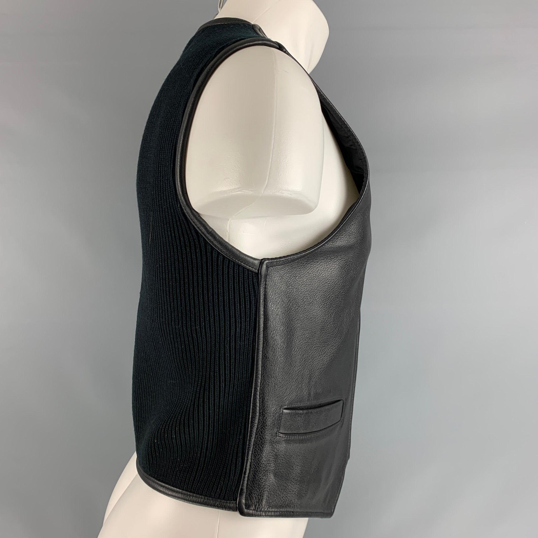 DONNA KARAN DKNY vest comes in a black leather front and knitted back panel featuring two welt pockets, and zip up closure. Excellent Pre-Owned Condition. 

Marked:   S 

Measurements: 
 
Shoulder: 15 inches Chest: 36 inches Length: 22.5 inches  
 
