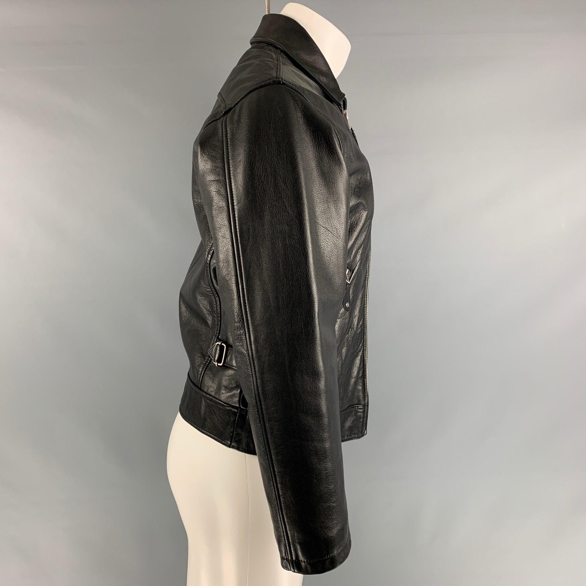 DONNA KARAN vintage jacket comes in black leather with a quilted lining, pointed collar, zip up front, and zipper pockets. Very Good Pre-Owned Condition. Minor signs of wear. 

Marked:   S 

Measurements: 
 
Shoulder: 19 inches Chest: 42 inches
