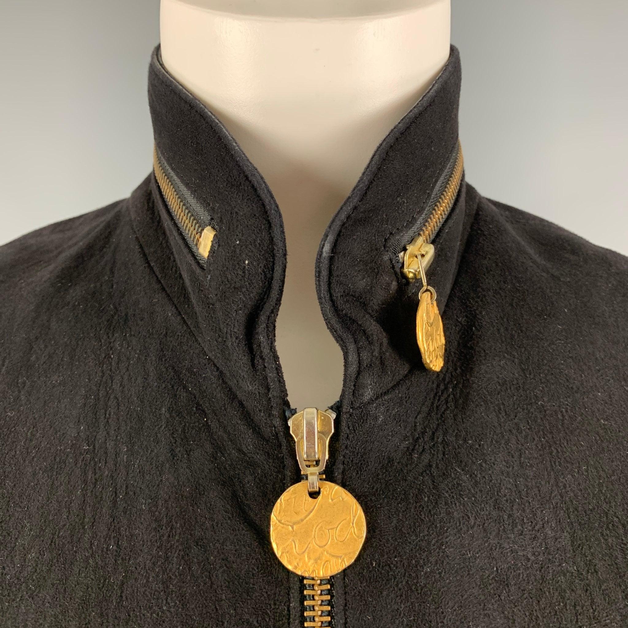 DONNA KARAN vest comes in a black suede material featuring zipper details, and gold hardware. Very Good Pre-Owned Condition. Minor signs of wear. 

Marked:   S 

Measurements: 
 
Shoulder: 12 inches Bust: 36 inches Length: 20 inches  

  
  
