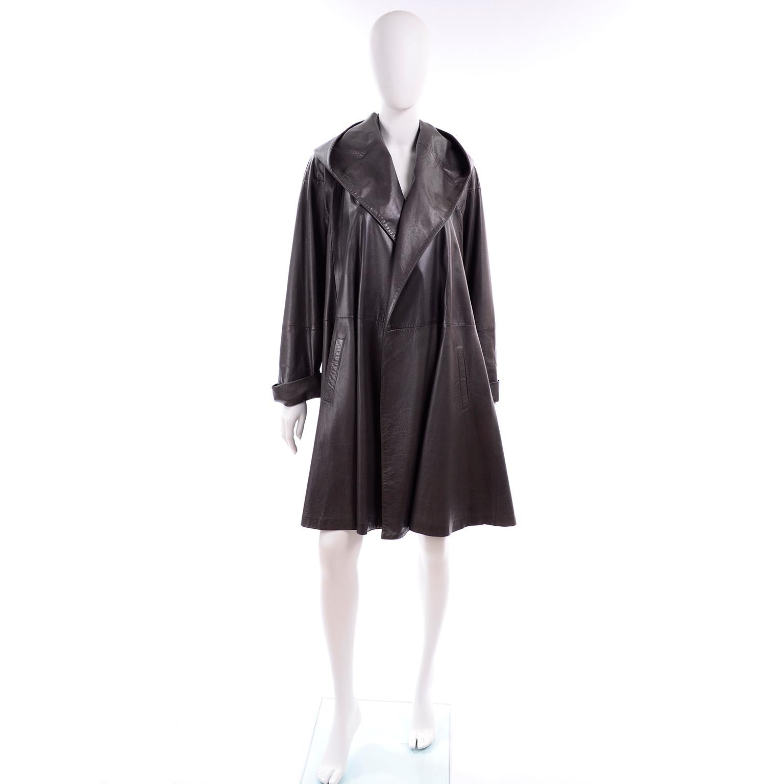 This early 1990's Donna Karan swing coat is one of the most incredible vintage leather coats we've seen in a while! The coat has a gorgeous hood that looks almost like a shawl collar, side slash pockets and it is fully lined in silk.  It is open in