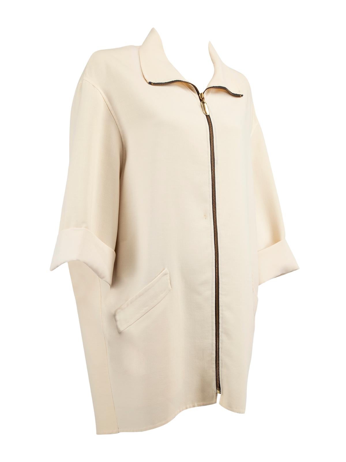 CONDITION is Good. Minor wear to coat is evident. There is a small hole/stain at the front on this used Donna Karen designer resale item.   Details  Cream Crepe Oversized coat Long sleeves Zip opening Fold up cuff 2x Front welt pocket    Composition
