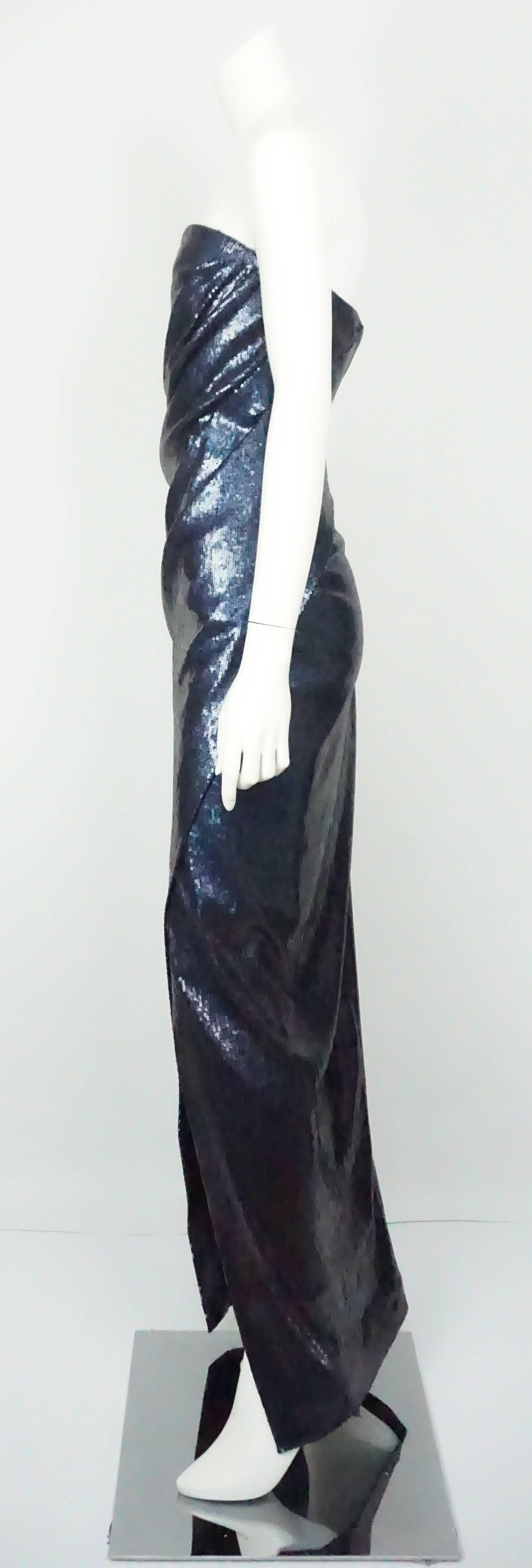 Donna Karen Navy Sequin Strapless Gown - 6 This spectacular fully navy sequin gown is lined with a tight knee length polyester and built in bra. There is a back zip, strapless, slight ruching in the front, and crosses in the front.