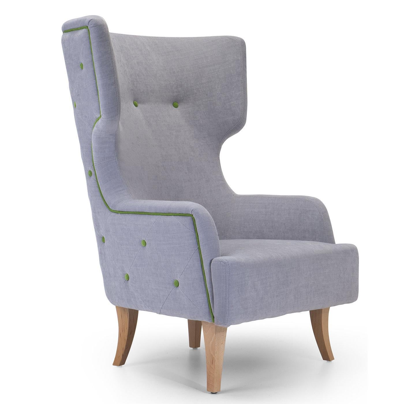 Characterized by a strong visual aesthetic that will suit both contemporary and traditional decors, this wingback armchair is both refined and inviting. The sinuous saber legs have a natural finish that complements the light gray Dacron upholstery,