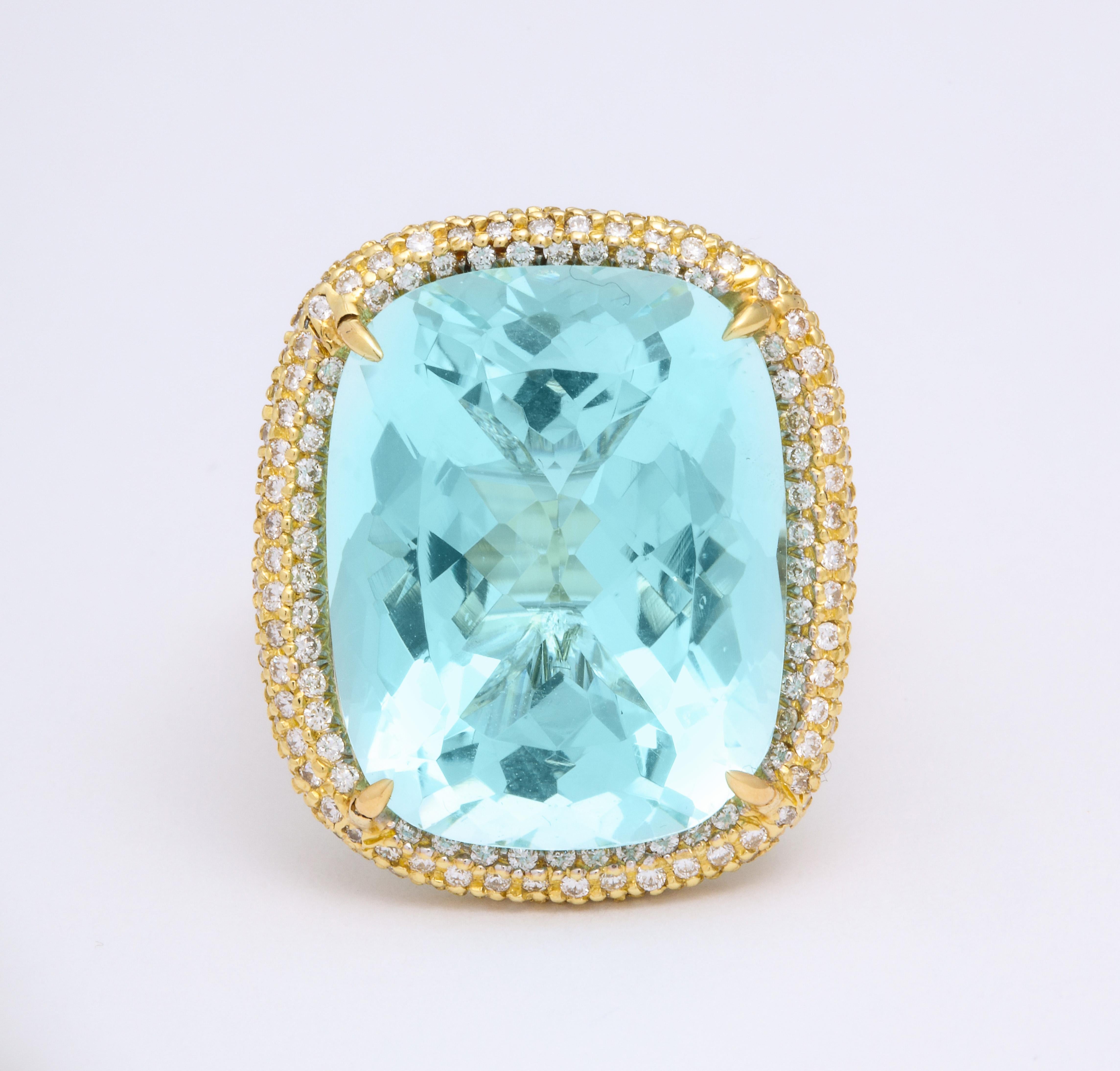 A ring in 18 karat yellow gold set with a 22.74 carat antique cut aquamarine. Surrounded by 360 round pavé set diamonds weighing a total of 1.72 carats. Ring size 6. Signed Donna Vock Designs