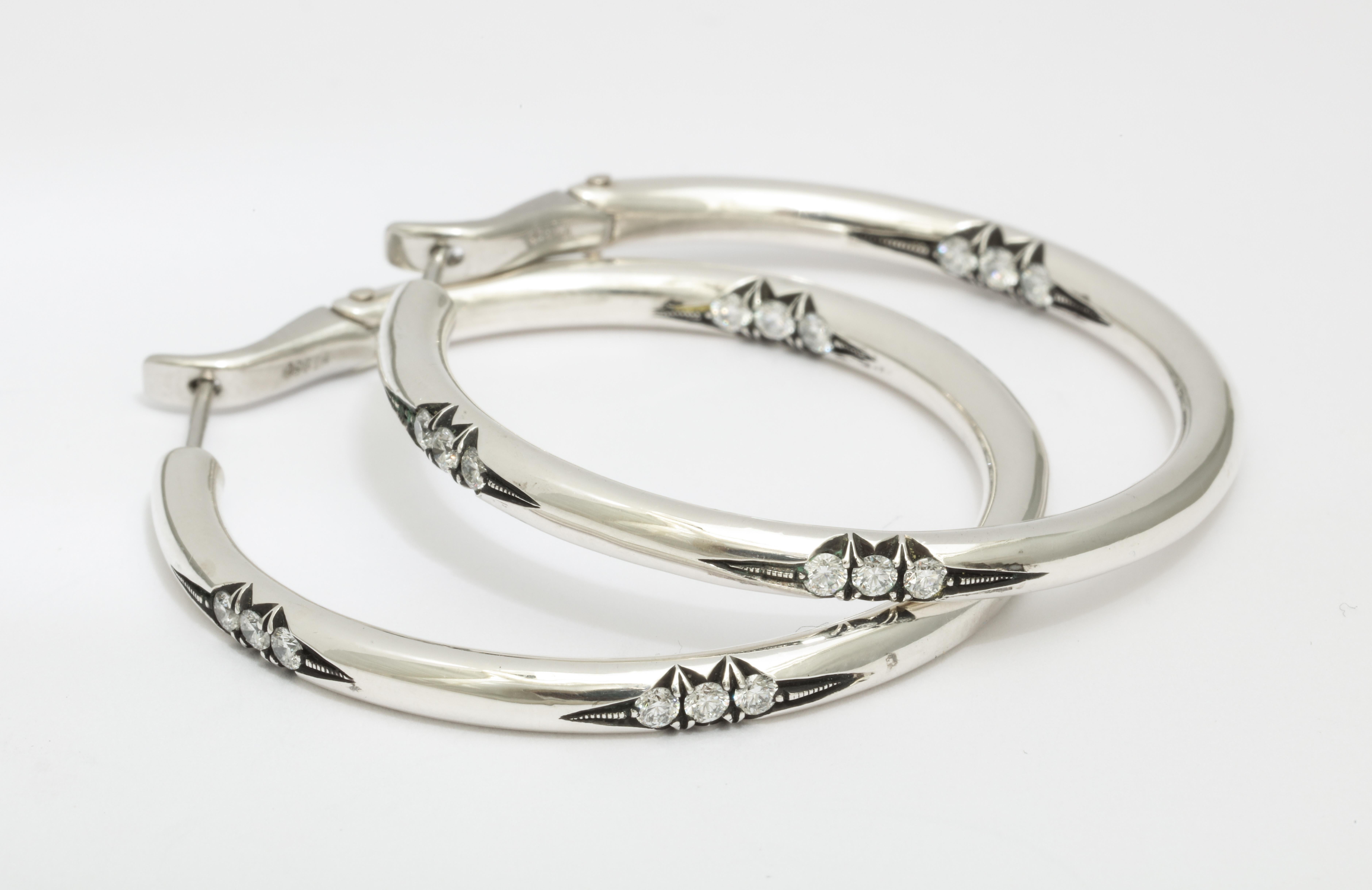 These hoops are designed to be striking yet comfortable, as well as versatile. They are the perfect size for day into night.  With just the right amount of diamond detail, ( approximately 1/2 carat total weight) the hand engraved design is inspired