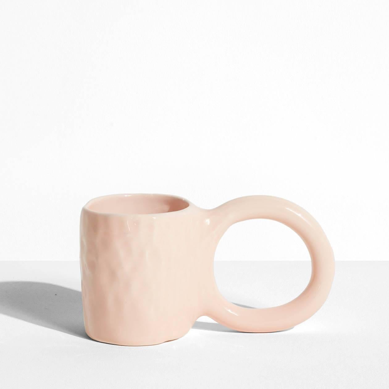 In creating the Donut collection, designer Pia Chevalier drew her inspiration from the world of baking. The ceramic artist imagined these cups and mugs as cakes – their handles representing the dough, and a varnished finish for a sugar-glazed