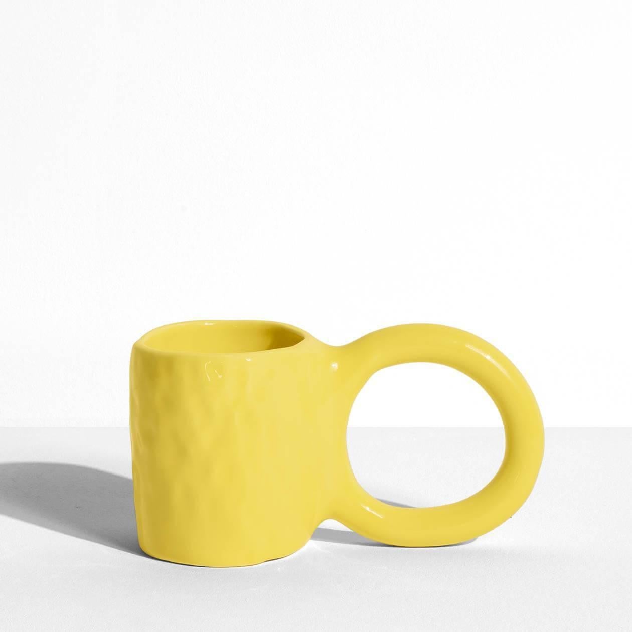 In creating the Donut collection, designer Pia Chevalier drew her inspiration from the world of baking. The ceramic artist imagined these cups and mugs as cakes – their handles representing the dough, and a varnished finish for a sugar-glazed