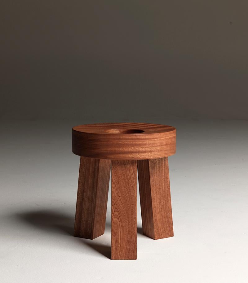 Donut, a fun and unexpected round stool with a central hole and modelled seat made of solid mahogany wood, a curious design, a friend for life. Designed by Aldo Cibic.