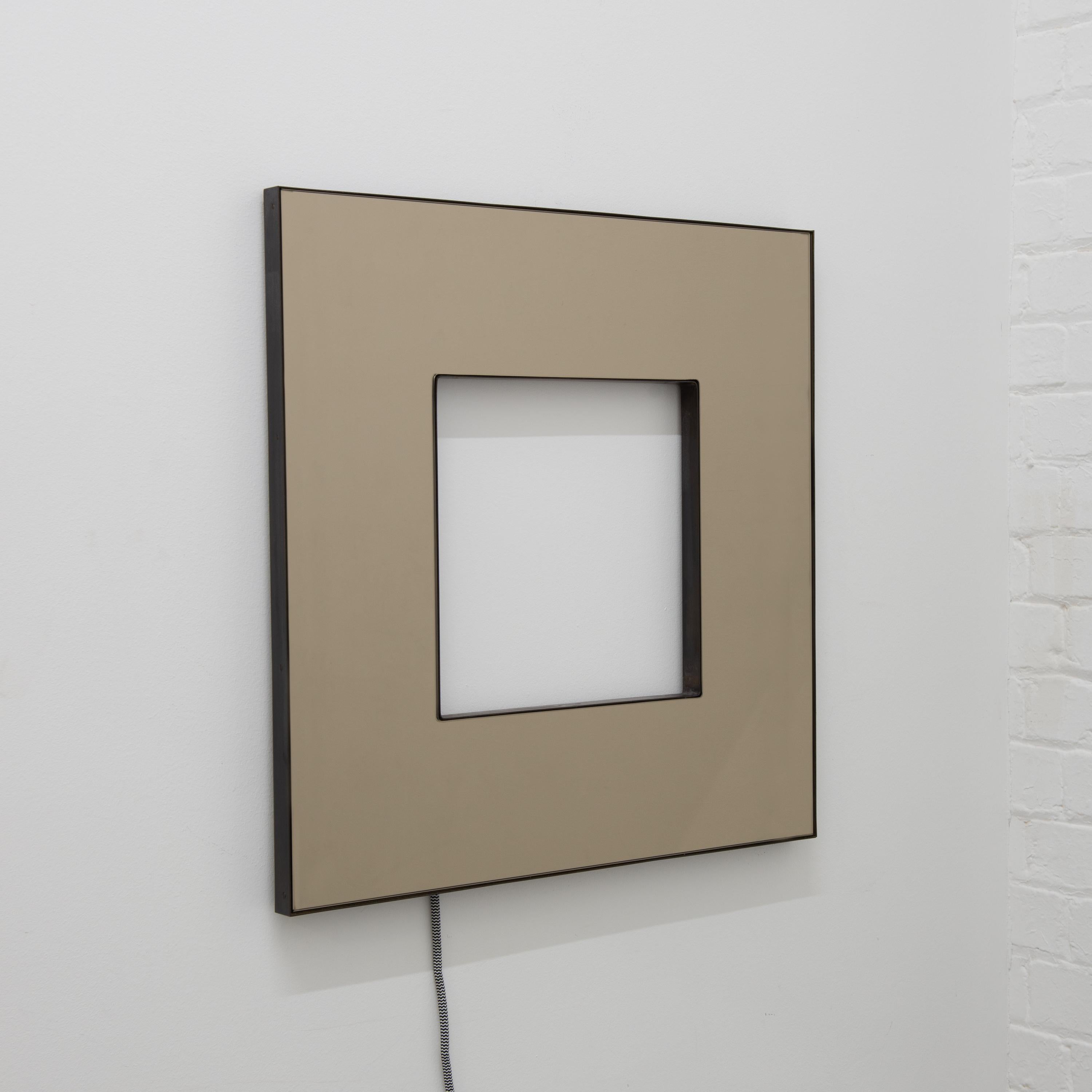 Contemporary Donut™ bronze tinted square mirror with a bronze patina brass frame and back illumination.

The latest creation by mirror designer Jose Luis Alguacil Rodriguez is a very exciting contemporary piece that offers a unique focal point for