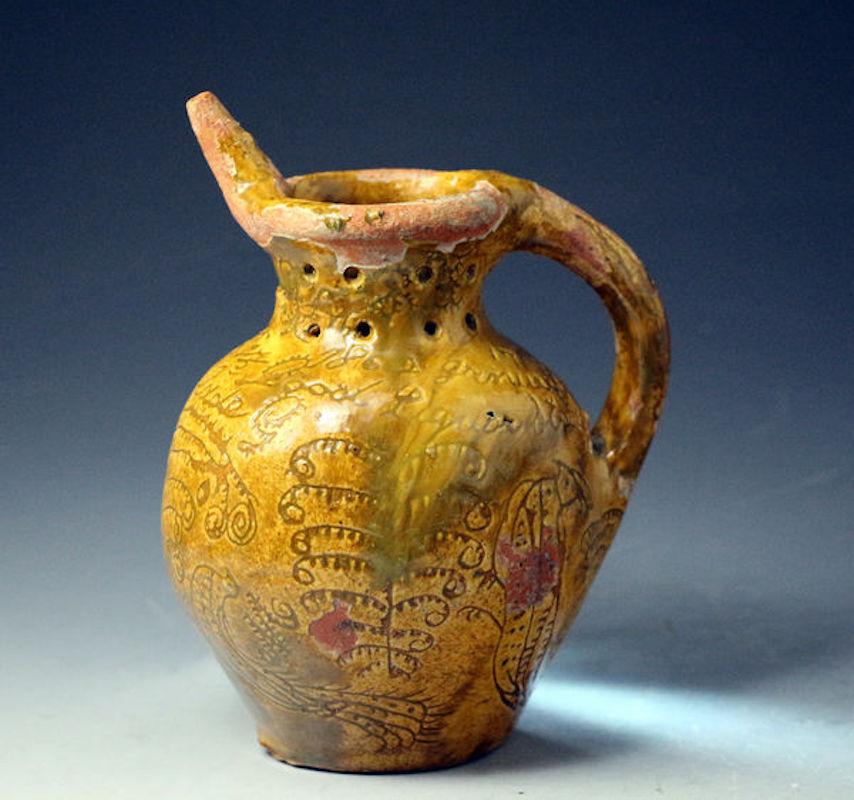 Donyatt Pottery Devon an earthenware slipware puzzle jug scraffito decorated named and dated James Greenslade Maker January 17th 1862. The jug is also inscribed with the motto 