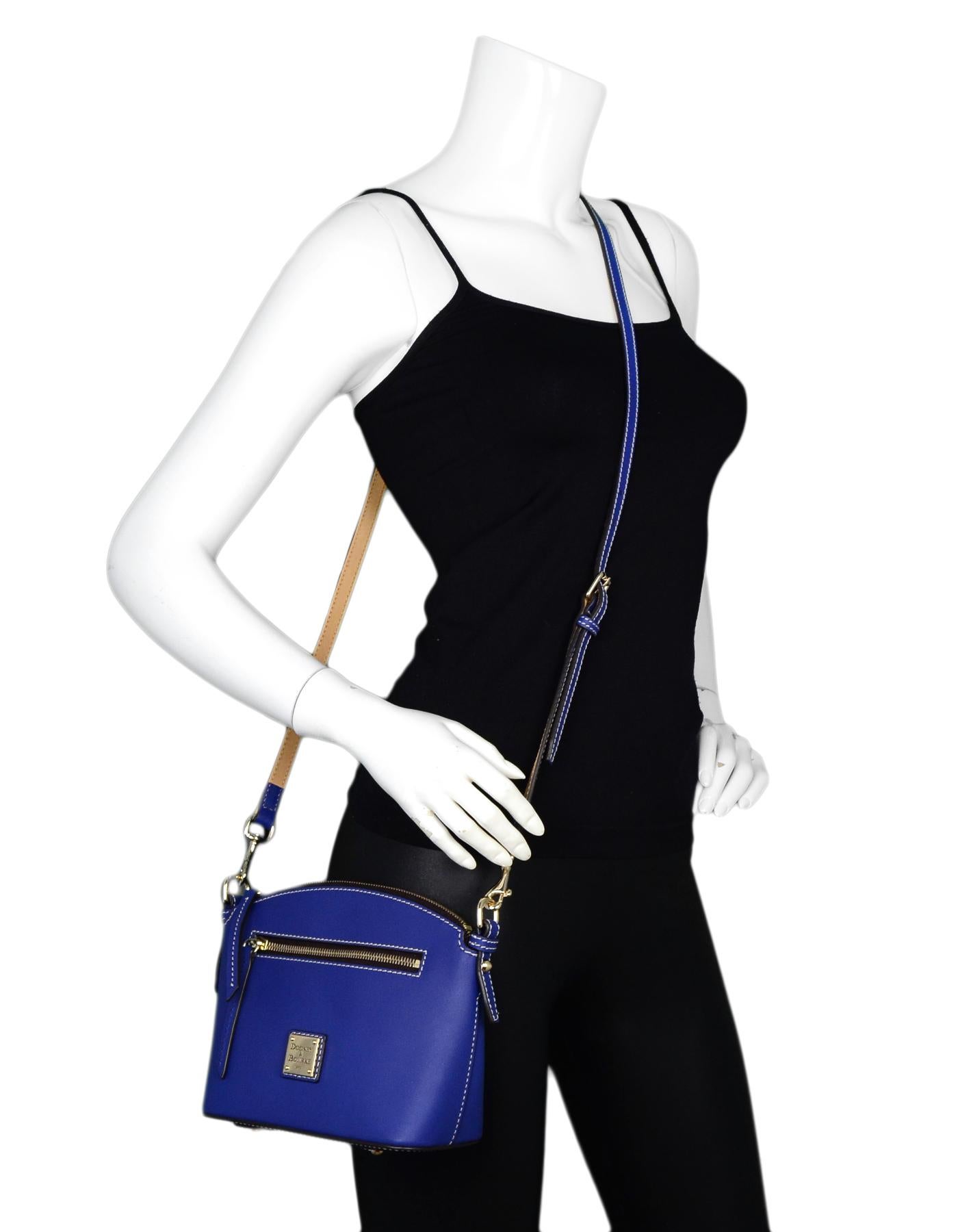 Dooney & Bourke French Blue Leather Domed Crossbody Bag

Color: French blue
Hardware: Goldtone
Materials: Leather, metal
Lining: Blue/white striped canvas
Closure/Opening: Zip top
Exterior Pockets: One front facing pocket
Interior Pockets: Two open