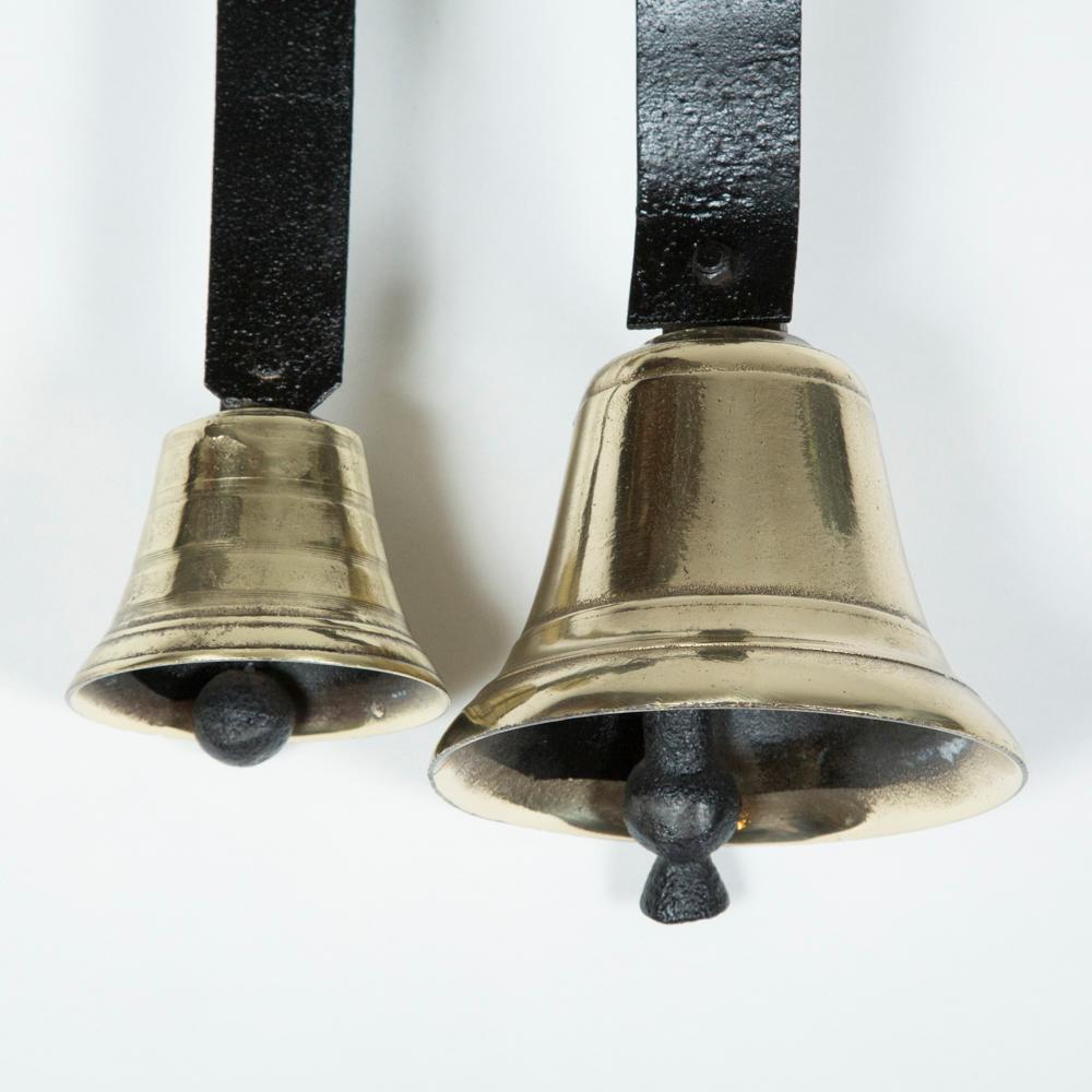 Two mid-19th century door bells on a sprung mounting plate.

Measures: Projection 9 inches.
 
