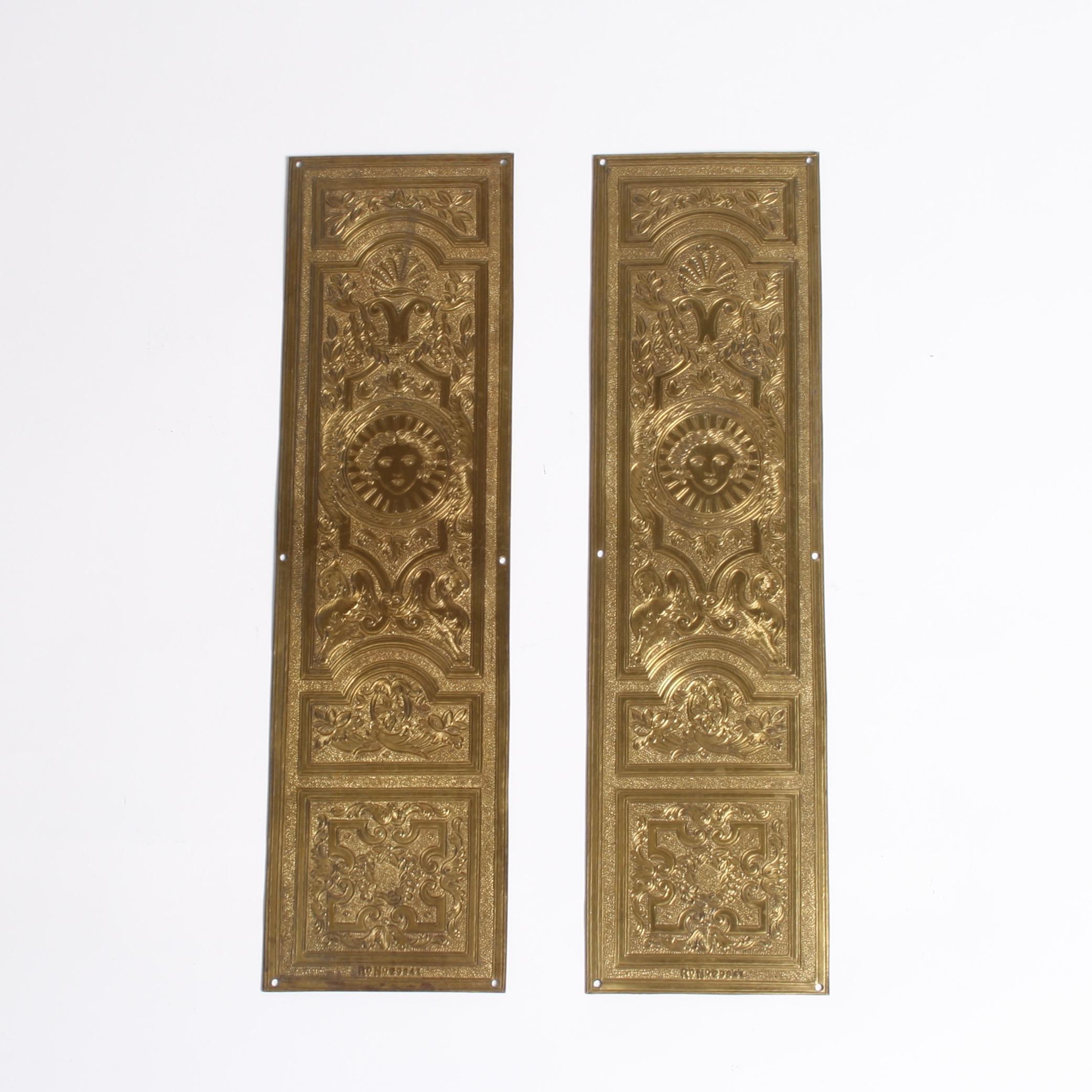 A pair of very ornate gilt brass door finger plates.

The bottom of each plate is marked with a registration number.
 