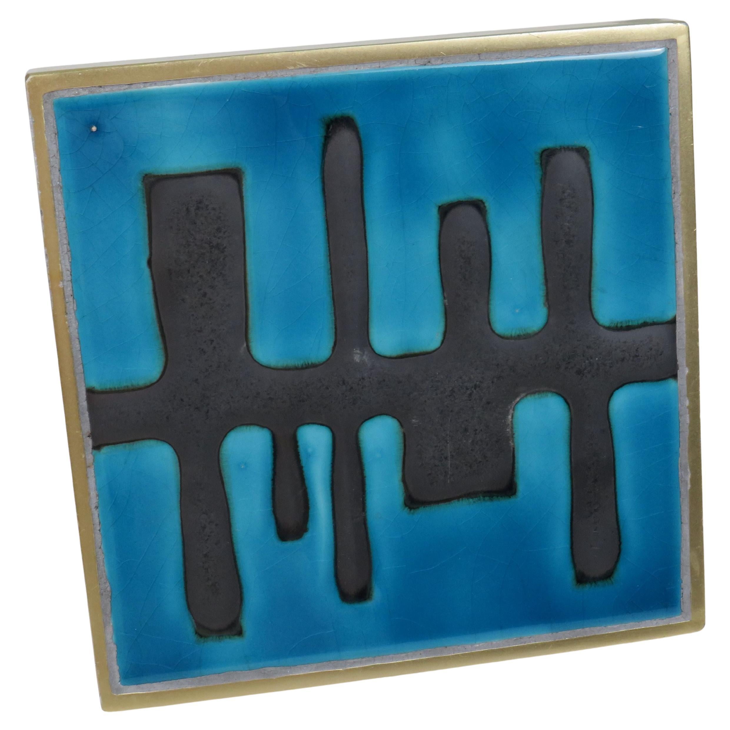 An elegant and collectible door handle by Sobinco, featuring a ceramic tile attributed to Amphora, Belgium, circa 1960. The design combines a geometric brass frame with a vibrant turquoise ceramic tile in bold abstract relief.

A tiny and discreet