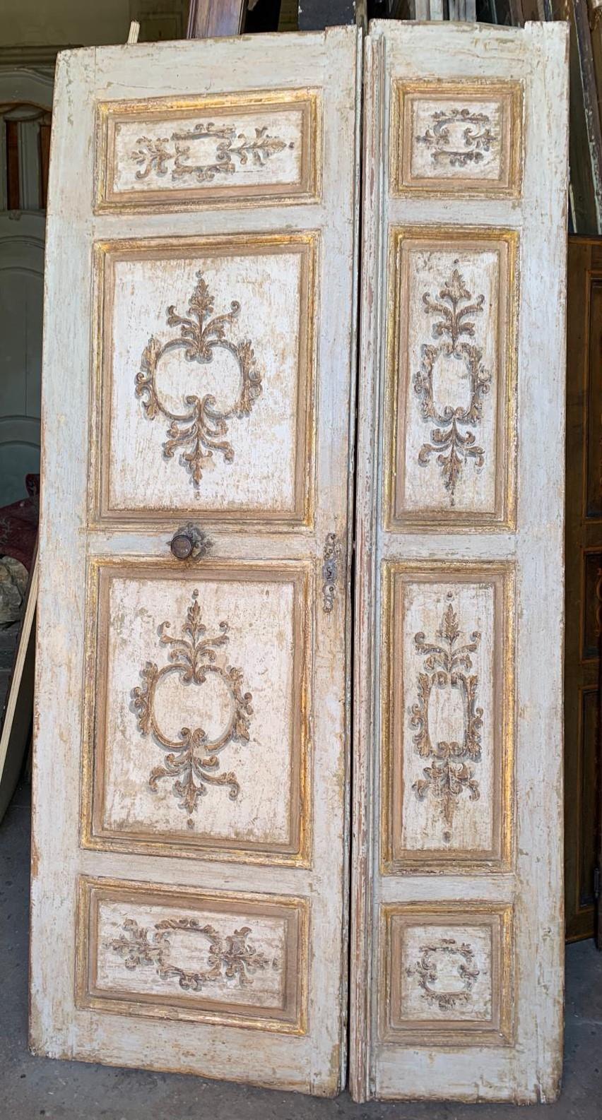 Ancient lacquered and richly hand-painted wooden door, with precious golden details in the panels painted in baroque shapes.
Made up of two doors, one wider and the other narrower, all original with lacquered back and beautiful butterfly irons. It