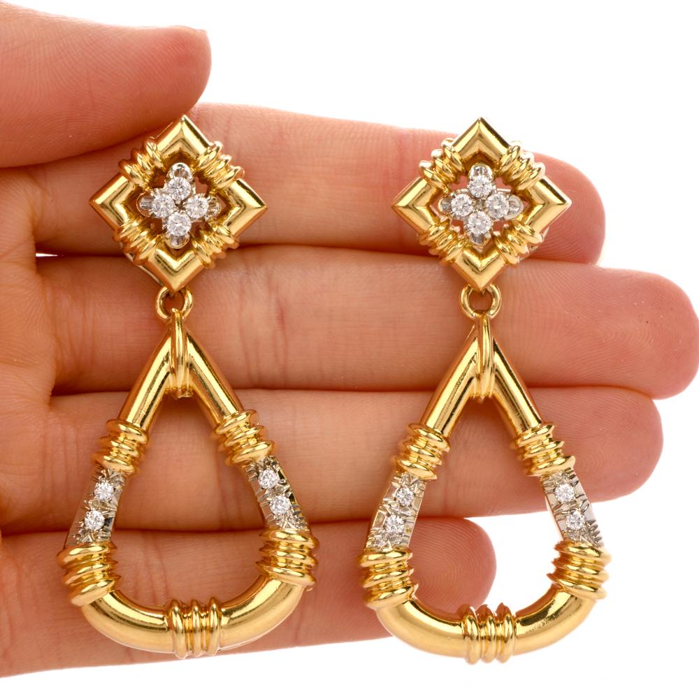 These chic late 70’s diamond and gold earrings are crafted in solid 18-karat yellow gold, weighing 39 grams and measuring 2.25” long x 29mm wide (max). It features 16 round cut, prong set diamonds, at the lobe and the drop, collectively weighing