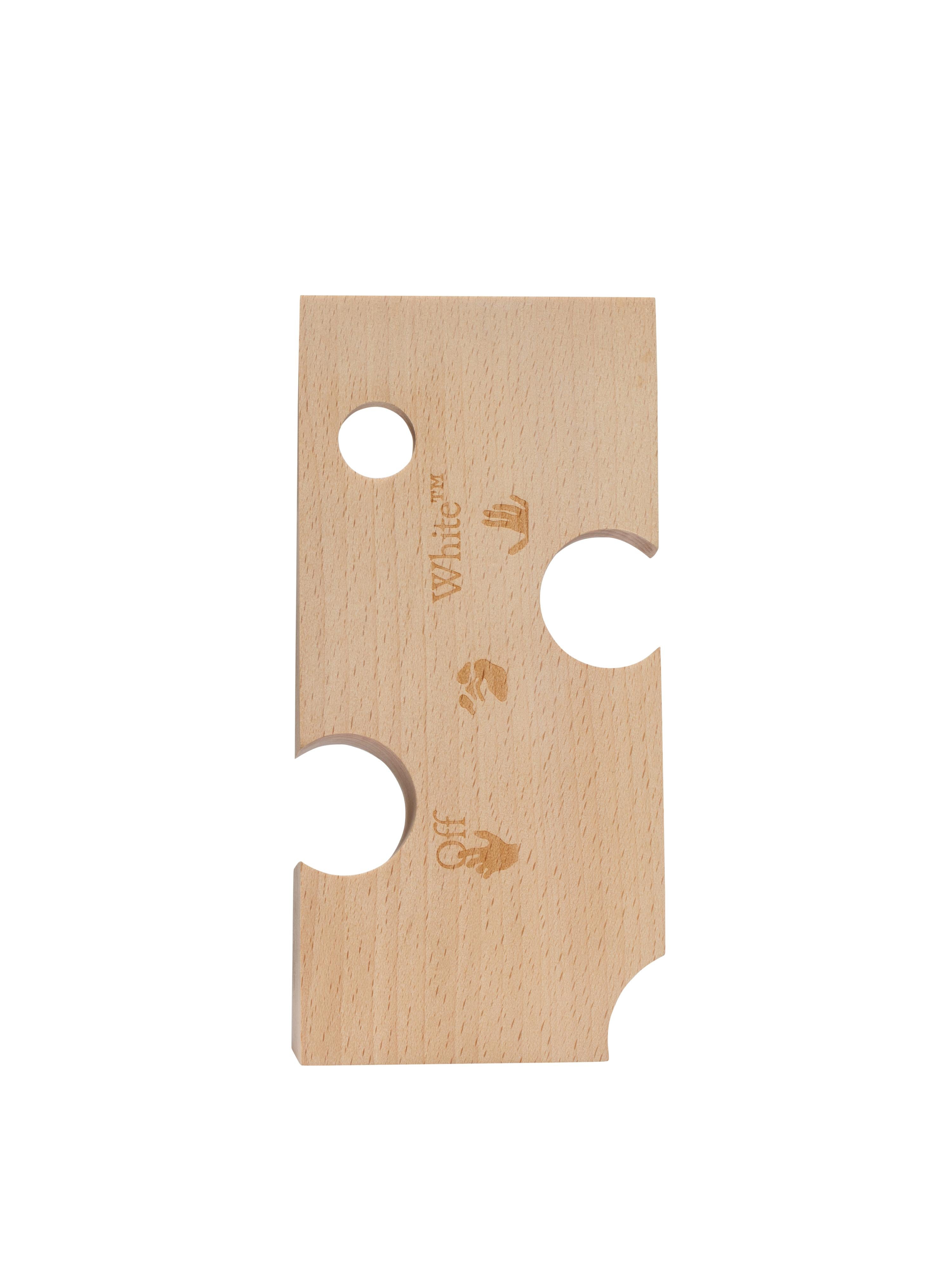 Holed wooden wedge - Swiss cheese shaped doorstopper with Man Swimming logo impressed - traditional doorstopper shape, holed and bigger than usual
By Virgil Abloh
Dimensions: 9 W x 19 D x 4.8 H
This item is only available to be purchased and