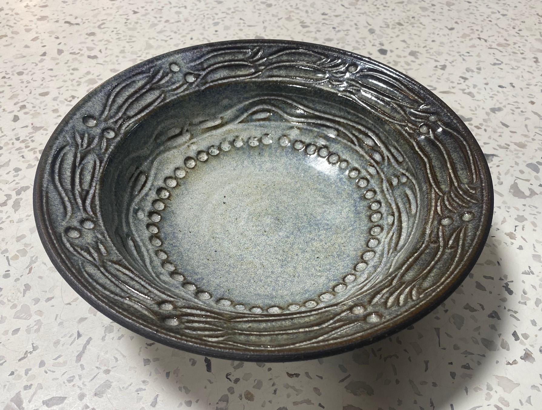 A beautifully designed and gorgeously glazed large bowl by famed Mexican-American California studio art potter Dora De Larios.   This piece was done late in her career and in collaboration with Irving Place Studio, her and her daughter's pottery