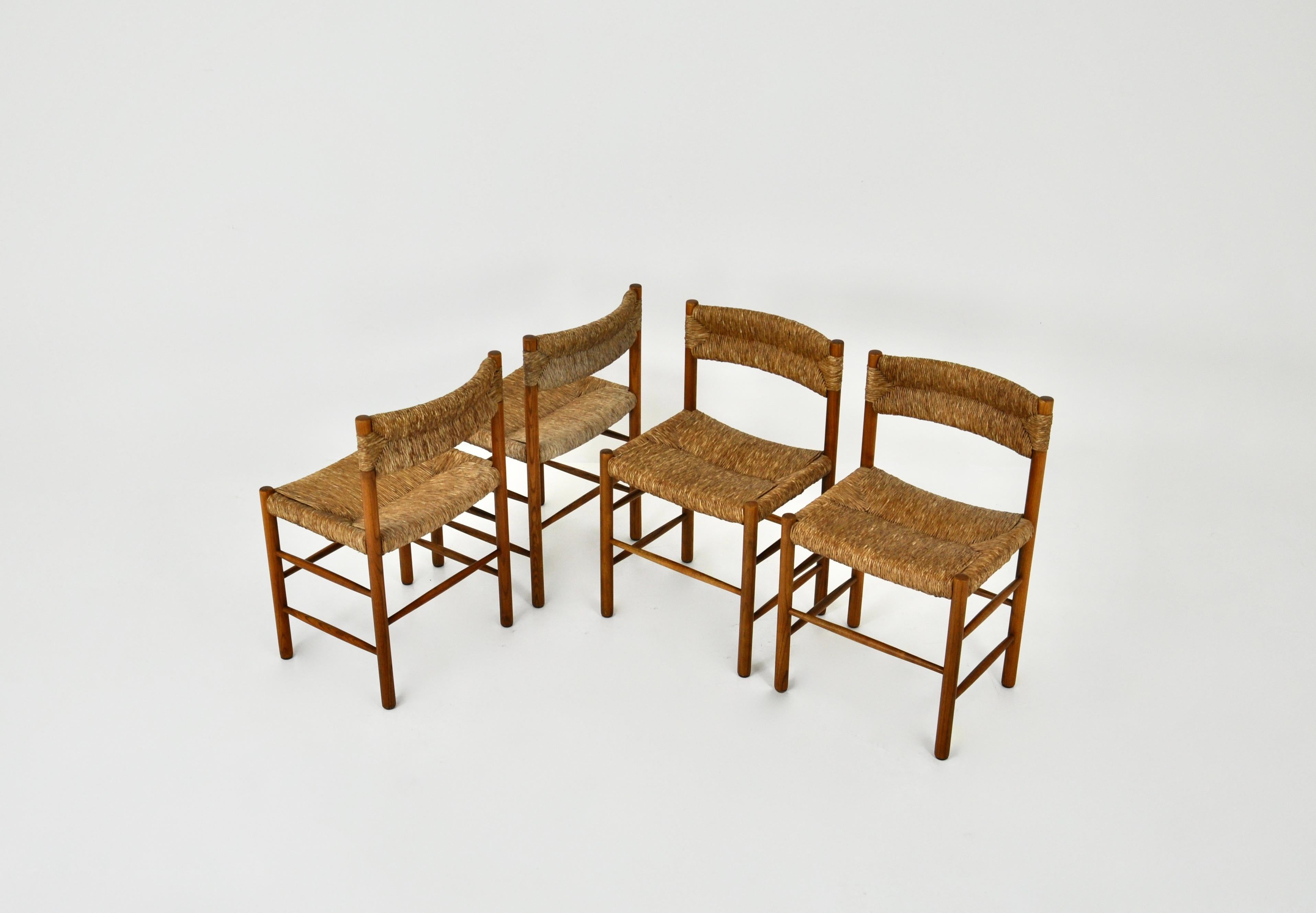 Set of 4 chairs in wood and straw made by Charlotte Perriand in the 1950s. Seat height: 46cm Wear due to time and age of the chairs.
