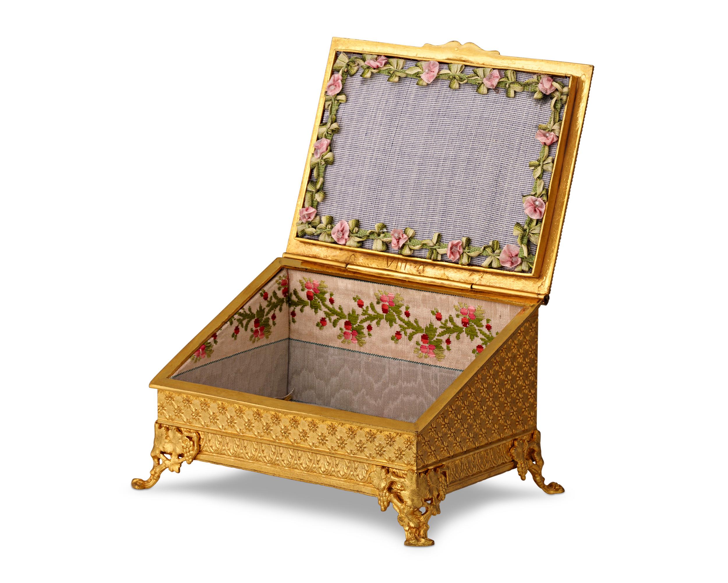 This exquisite French writing desk casket is a stellar example of neoclassical craftsmanship. Fashioned from Doré bronze and adorned with royal blue enamel, it features a classical tableau intricately carved to showcase ancient aesthetics. The