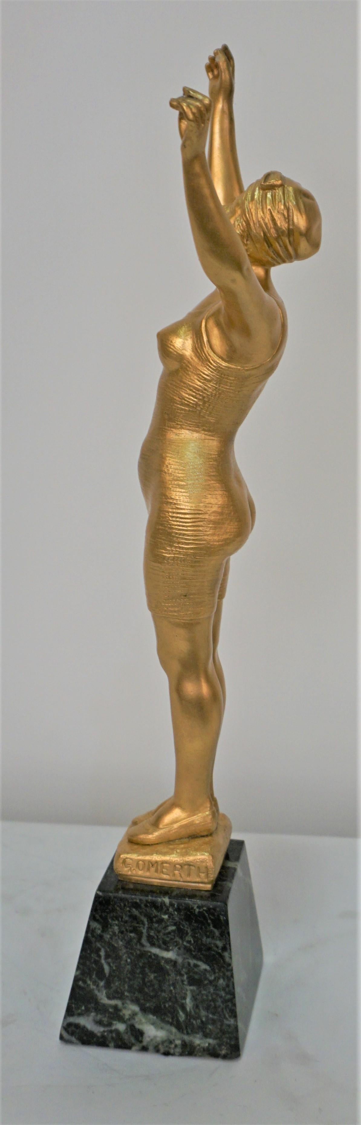 Dore bronze of a female figure in swimwear standing an marble by George Omerth.