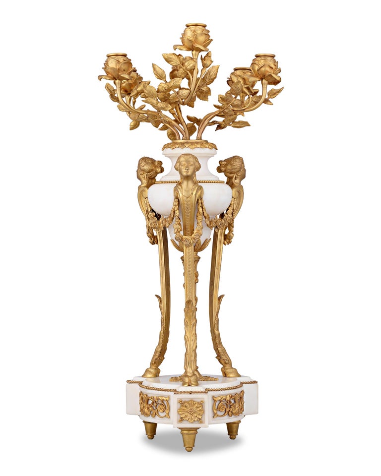 This outstanding pair of French Second Empire candelabra exemplifies the grandeur and exuberance of this decorative era. Expertly crafted of doré bronze and white marble, these lights are designed in the neoclassical style, with dramatic acanthus