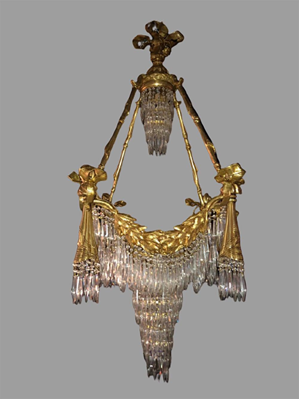 Bronze Louis XVI style crystal ribbon and tassel drapery chandelier with 18 lights. Newly wired. This fine custom quality chandelier is simply stunning and are certain to light up any area of the home. The ribbon and tassel form doré bronze fixture