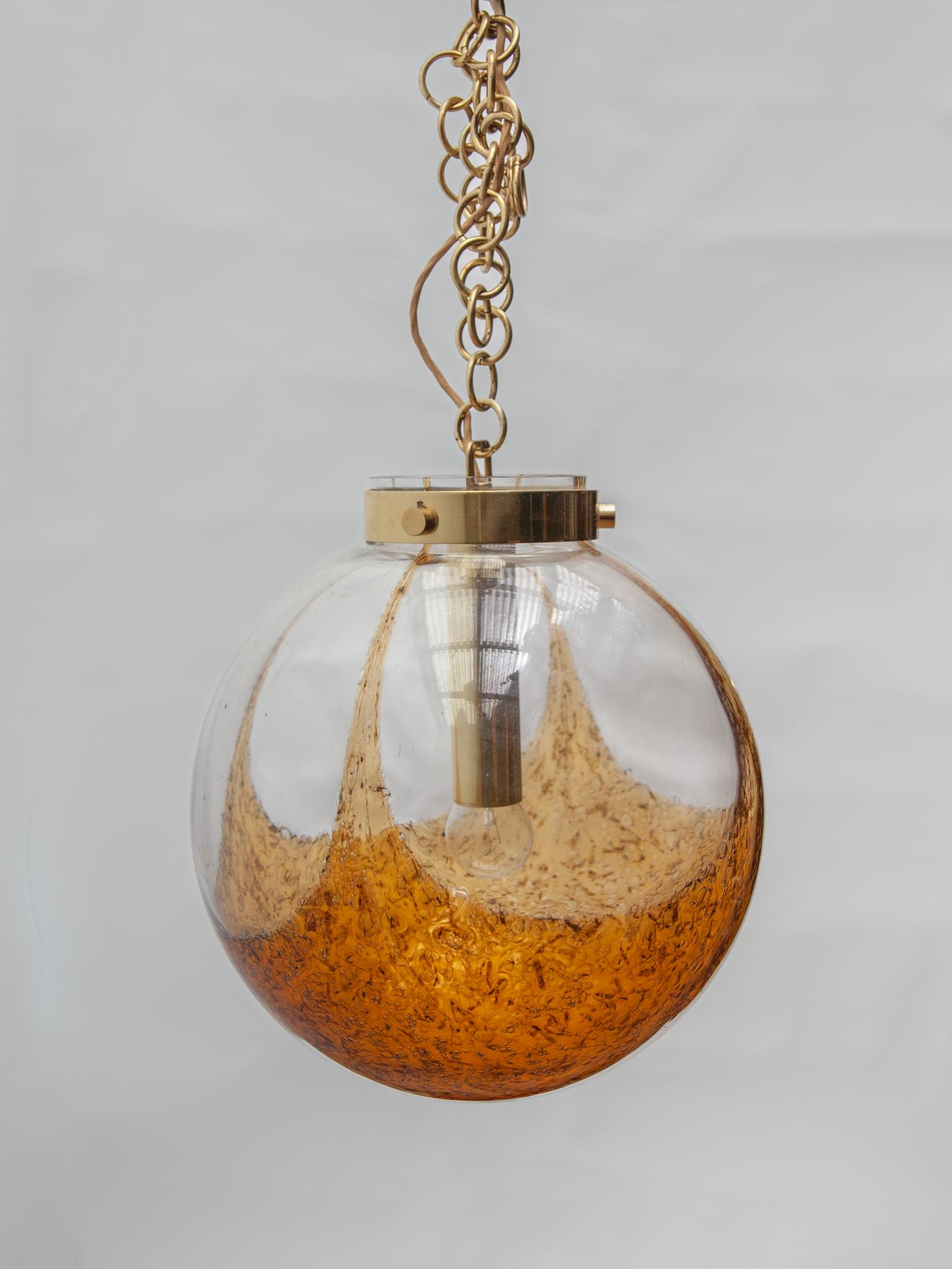 German Doria Amber and Clear Glass Globe Pendant. For Sale