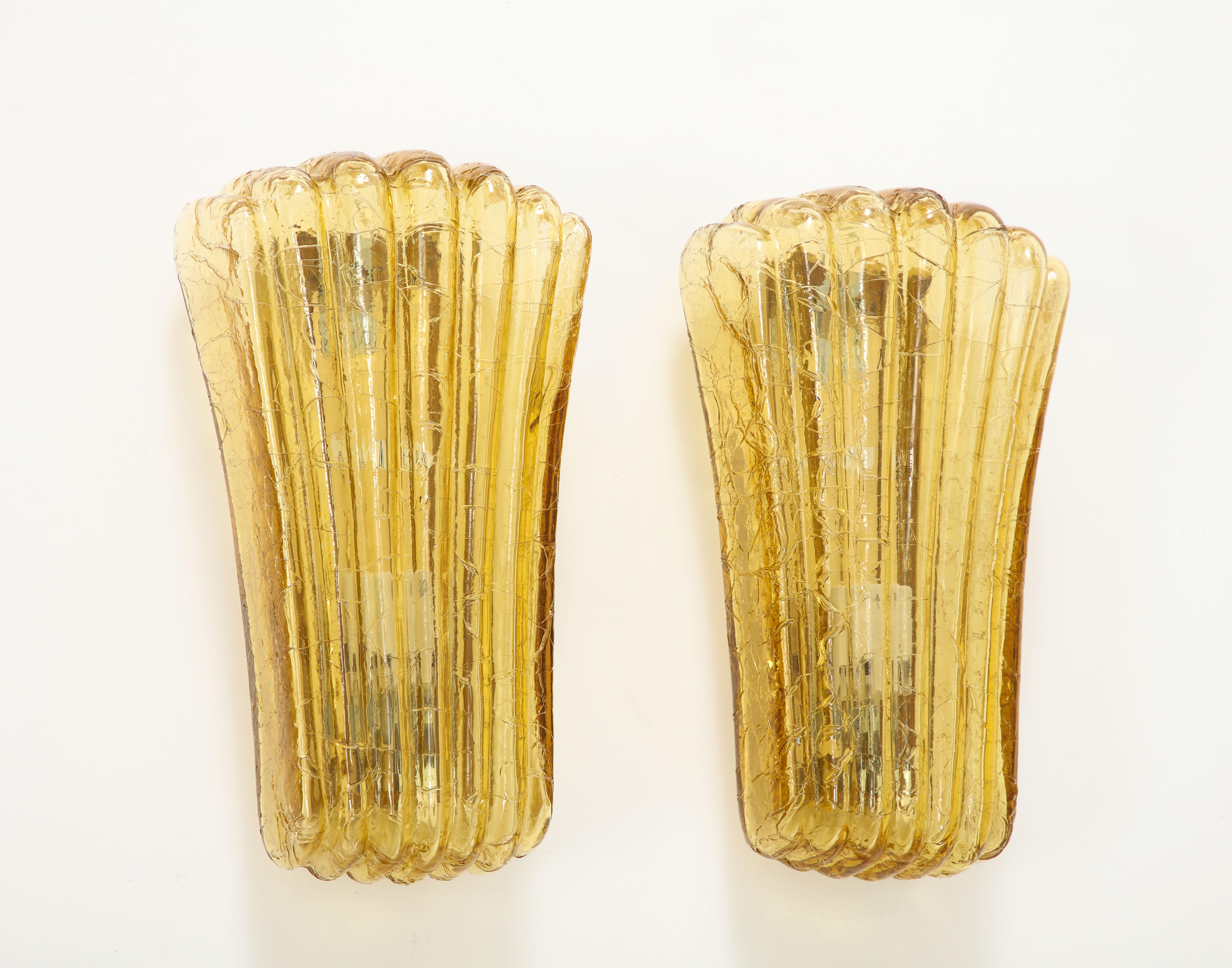 Modernist stylized amber glass shell sconces by Doria. Sconces have been rewired for use in the USA by an UL listed electrician. Currently 2 pairs are available, 3400 Per pair 