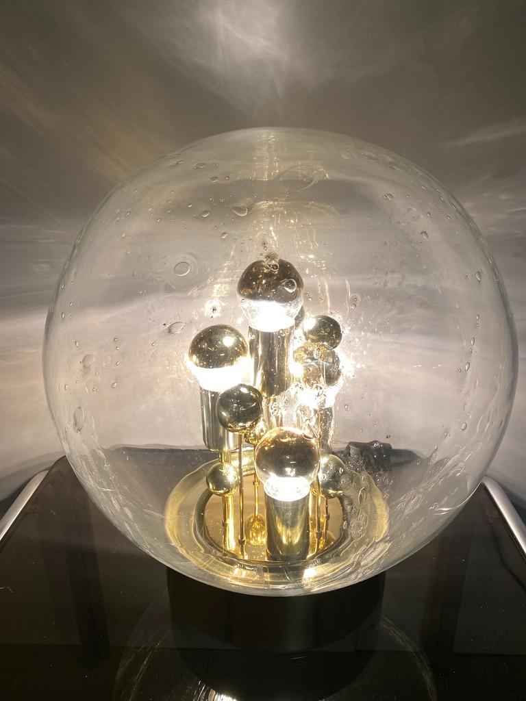 Magical Space-Age lamp by Doria, Germany. The galaxy in a lamp, a Big Ball lamp. You expect battleship Galactica to pass by at any moment. A true design icon from the Space Age era.

The ball is made of hand-blown glass, you can see bubbles