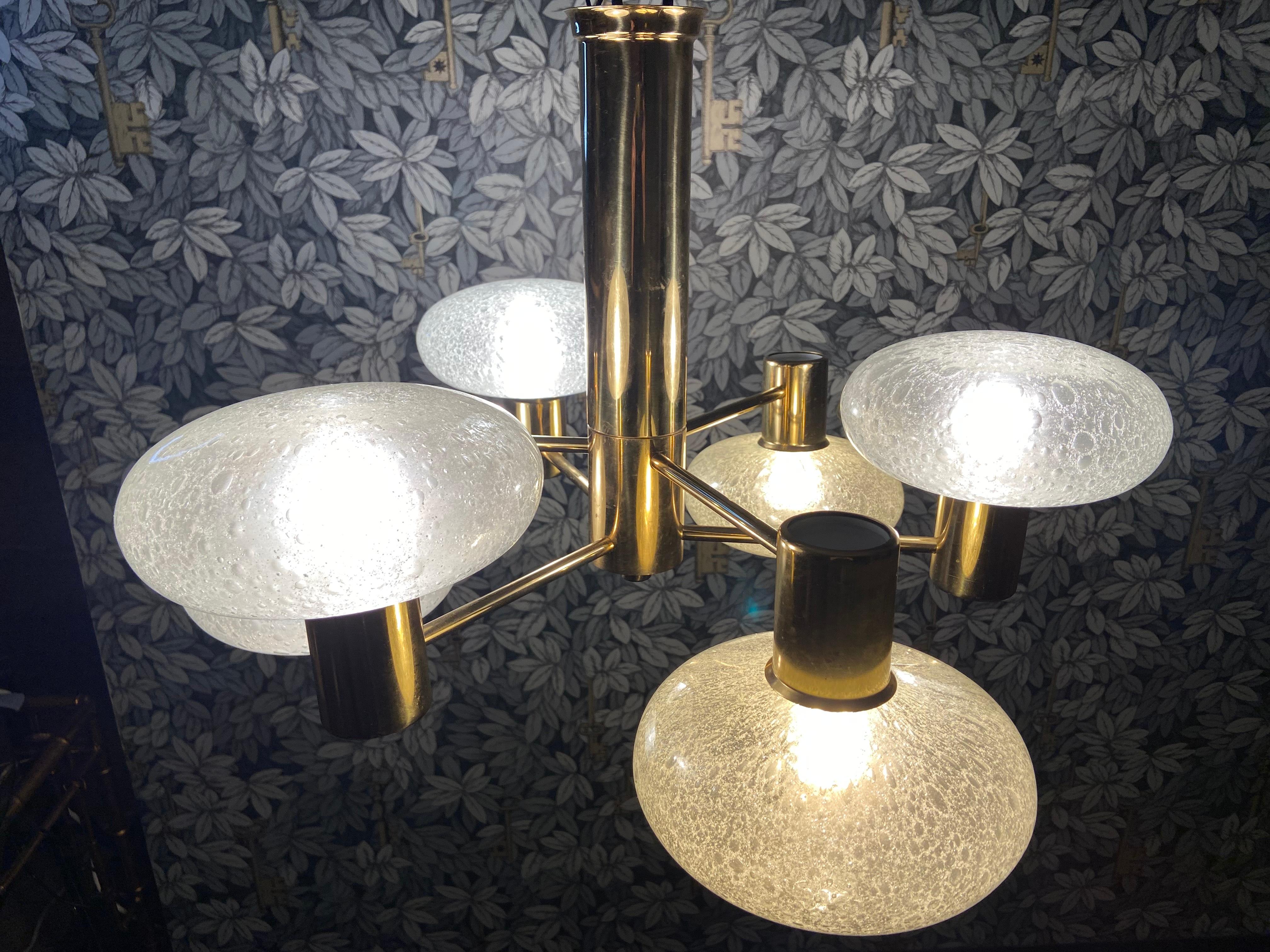 Fabriqué par Condit à Furth, en Allemagne, au début des années 70, ce lustre décoratif en laiton avec 6 sphères en verre aplati soufflé à la main est en très bon état.

Suspendues à une colonne centrale encastrée, 6 branches sont disposées à des