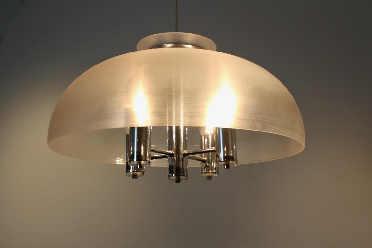 Beautiful pendant by Doria Leuchten, Germany, 1960s. The pendant comes with a Lucite Dome with inside a small chrome chandelier with 5 lights. It has a classic look: it is pure, simple and it gives a very stylish light. The height of the pendant is