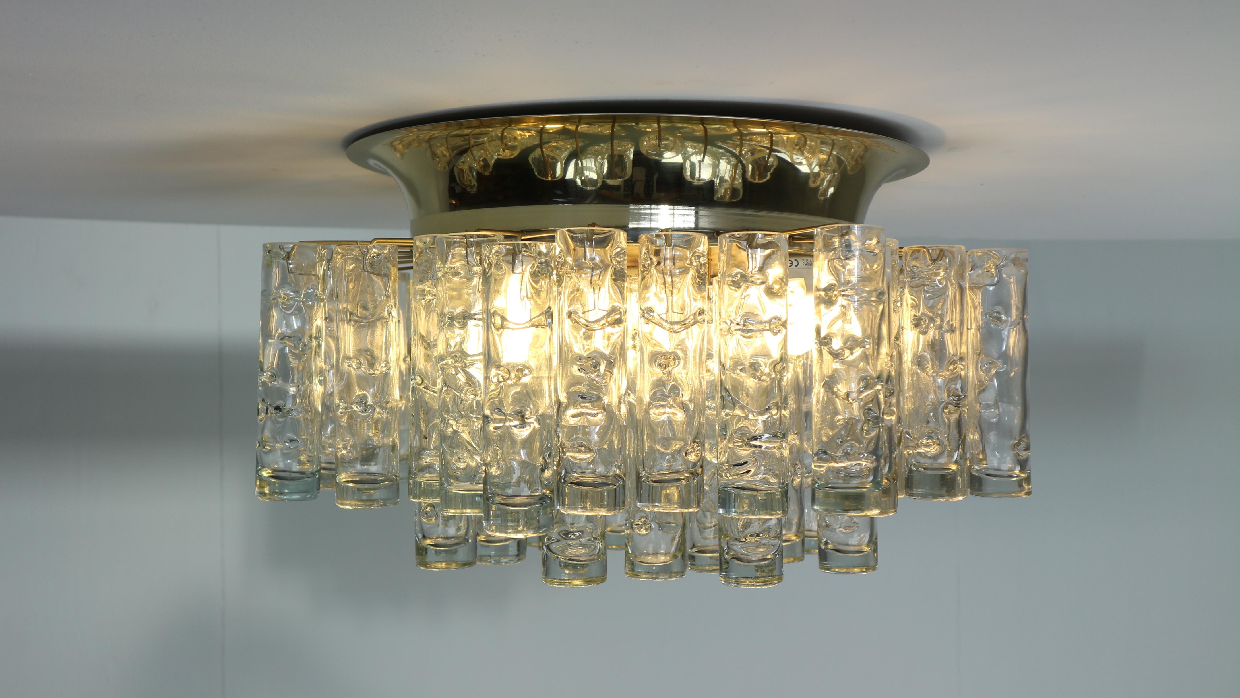 Fantastic midcentury chandelier by Doria, Germany, manufactured in the 1960s. 49 Murano glass cylinders suspended from the fixture.

Heavy quality and in very good condition. Cleaned, well-wired and ready to use. The fixture requires five E27