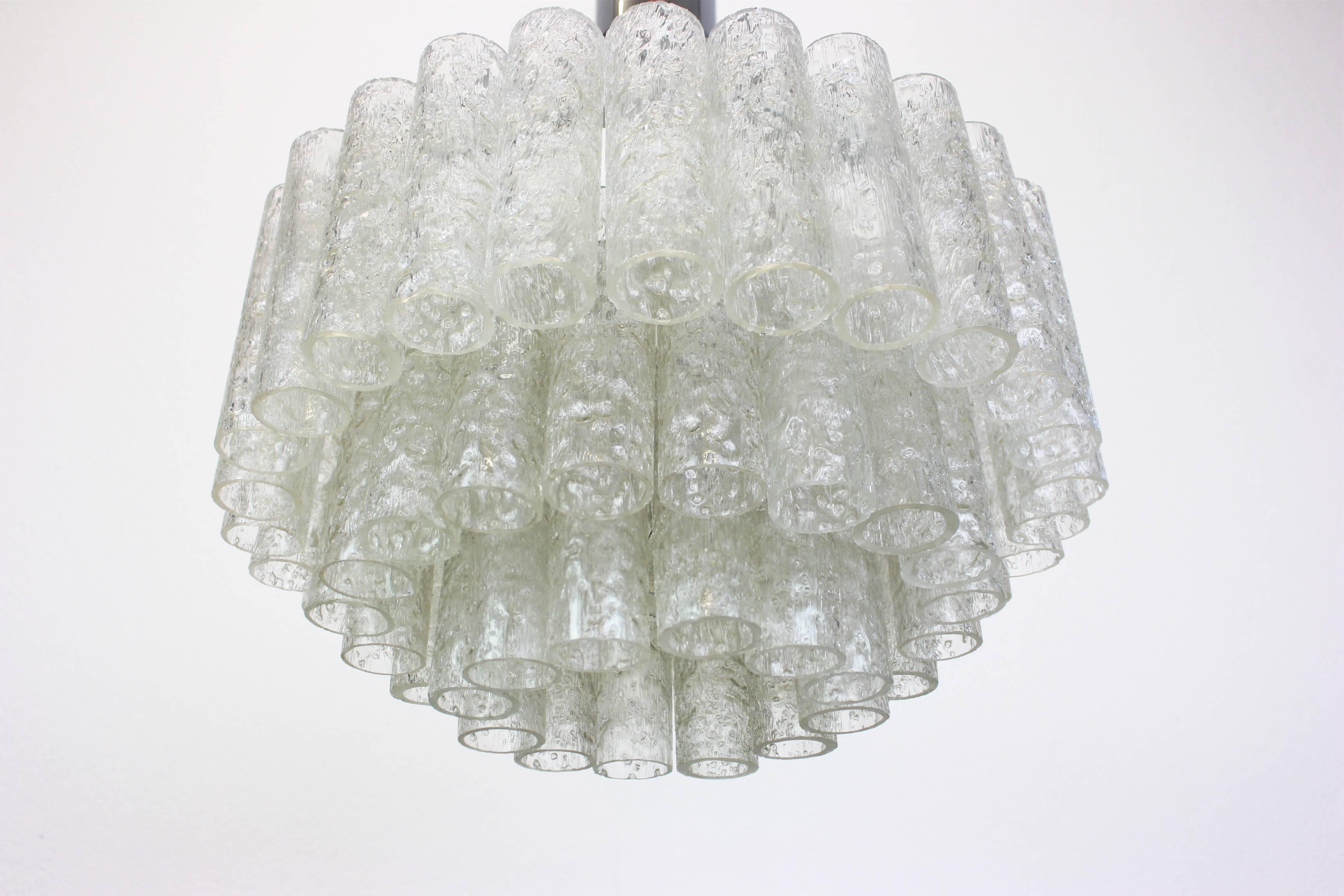 Fantastic three-tier midcentury chandelier by Doria, Germany, manufactured circa 1960-1969. Three rings of Murano glass cylinders suspended from a fixture.

Sockets: 4 x E14 candelabra bulbs (up to 40 W each) + 1 x E27 Standard
Light bulbs are not
