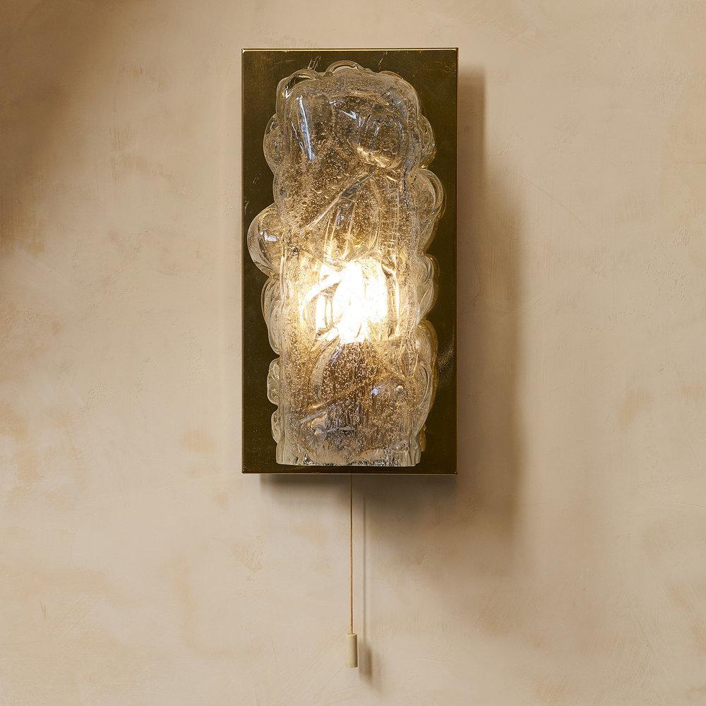 A pair of handblown glass sconces from the 1970s; manufactured by Doria Leuchten in Germany. Frosted, biomorphic glass shades mounted on brass plate cast a warm glow. The On/Off Pull cord is a nice option for bedside lighting; though this feature is
